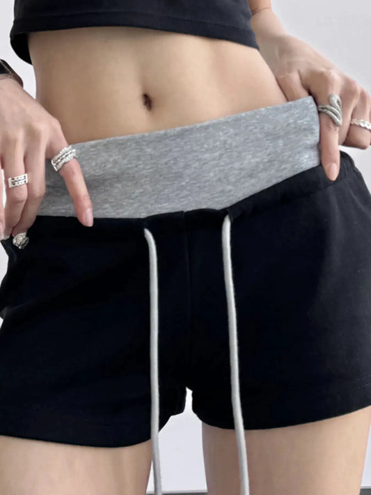 Drawstring shorts with contrast grey waistband and white drawstrings on black fabric