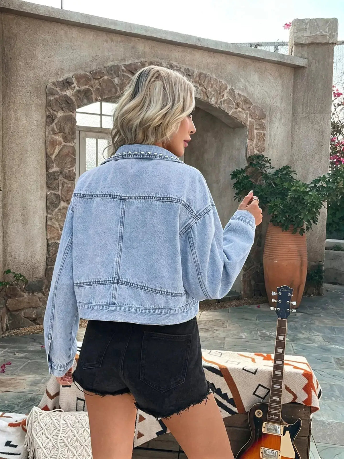 Premium Studded Button Front Denim Jacket by Trendsi, light-wash denim with silver studs.