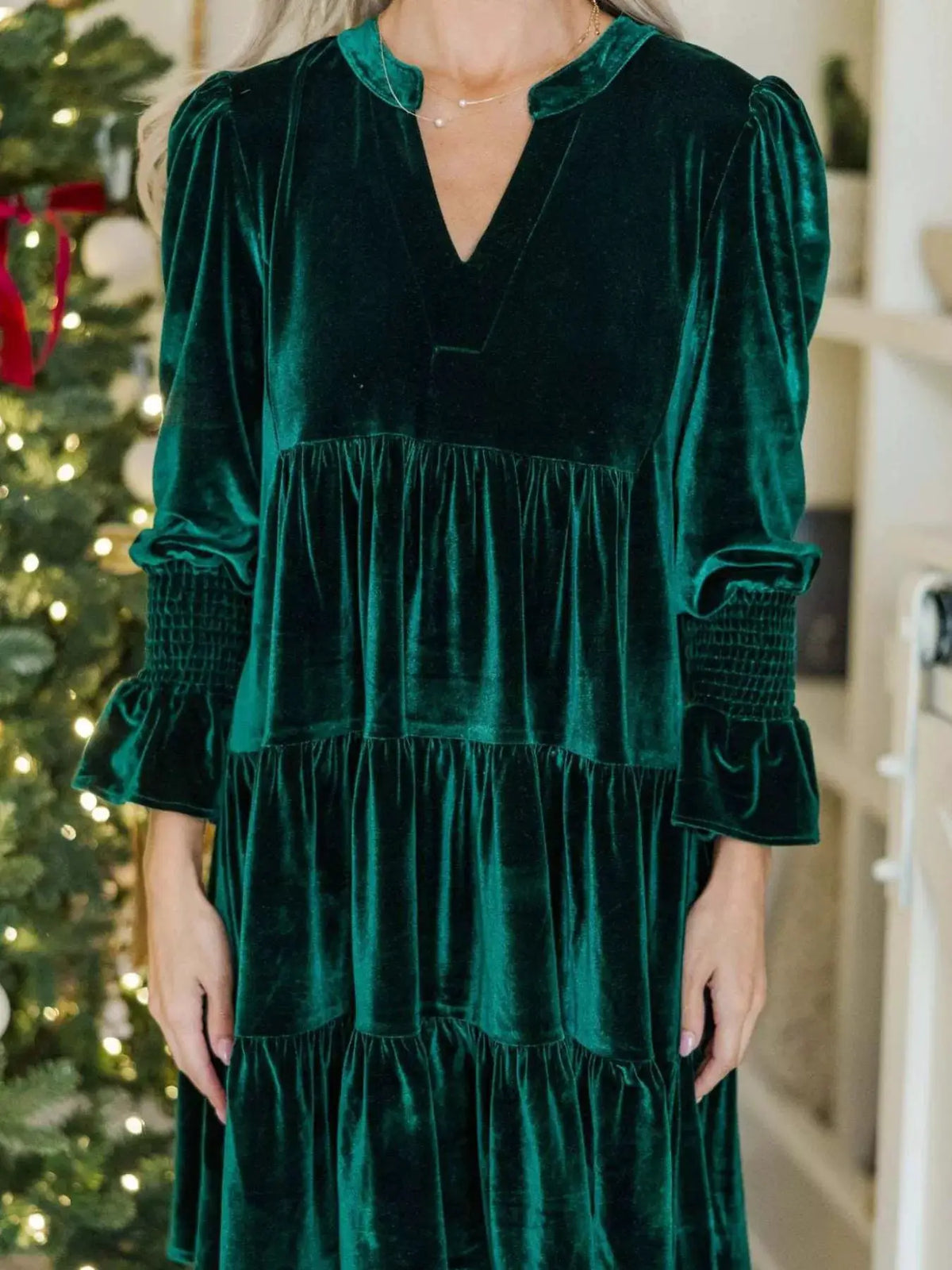 Velvet Tiered Notched Mini Dress in emerald green with long puff sleeves and smocked cuffs.