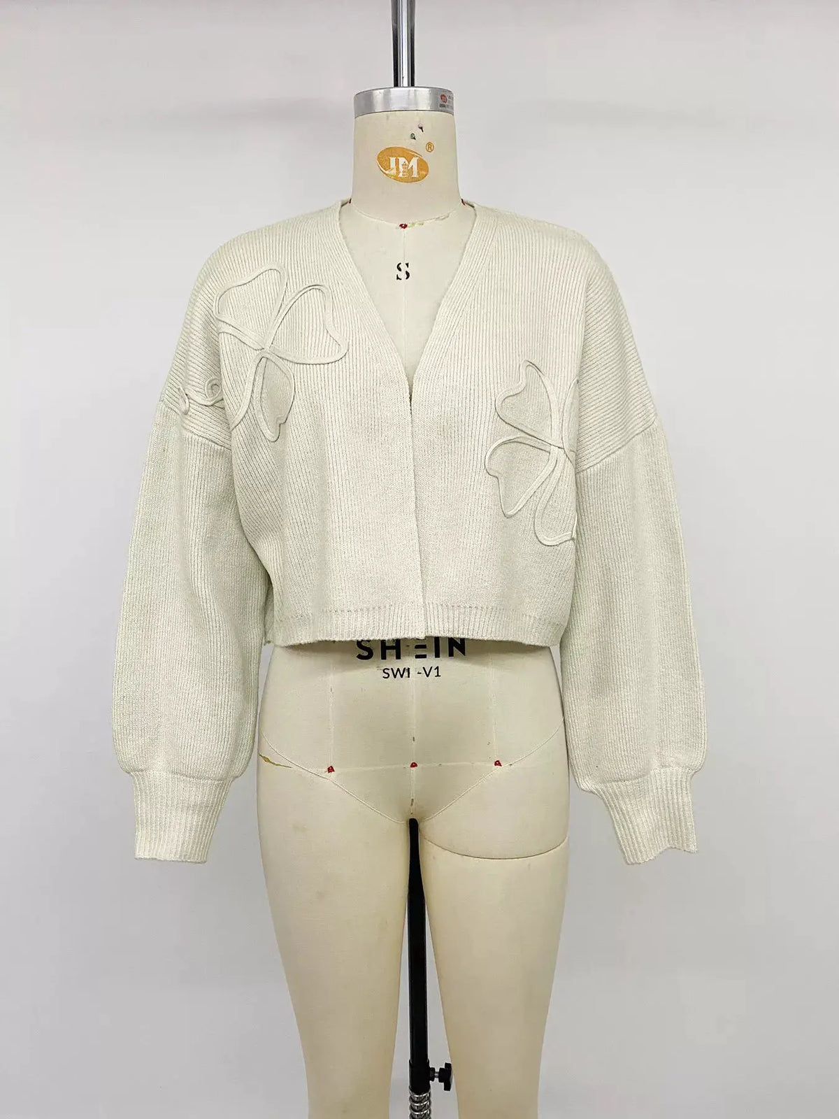 Four-Leaf Clover Open Front Cardigan, ivory knit with clover appliqués, cropped length with ribbed cuffs.
