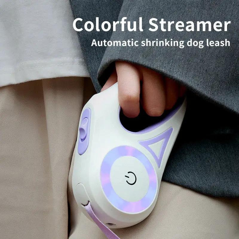 Dog retractable leash with white body and purple accents, pink strap
