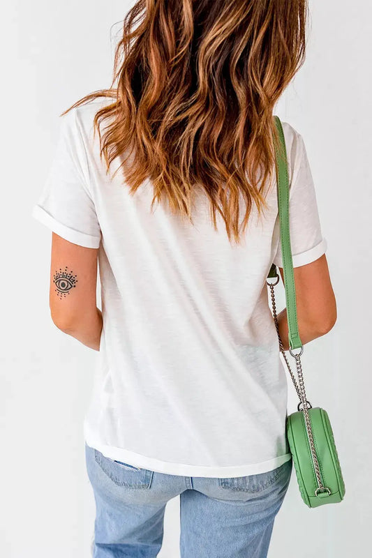 Plus-size white graphic Halloween T-shirt back view, paired with light wash jeans and a green crossbody bag