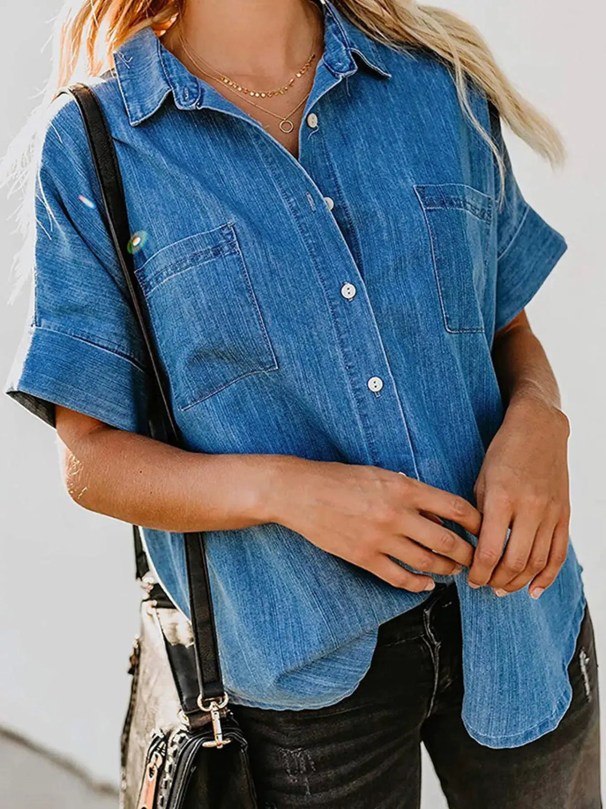 Casual blue denim short-sleeve shirt with button front and chest pockets.