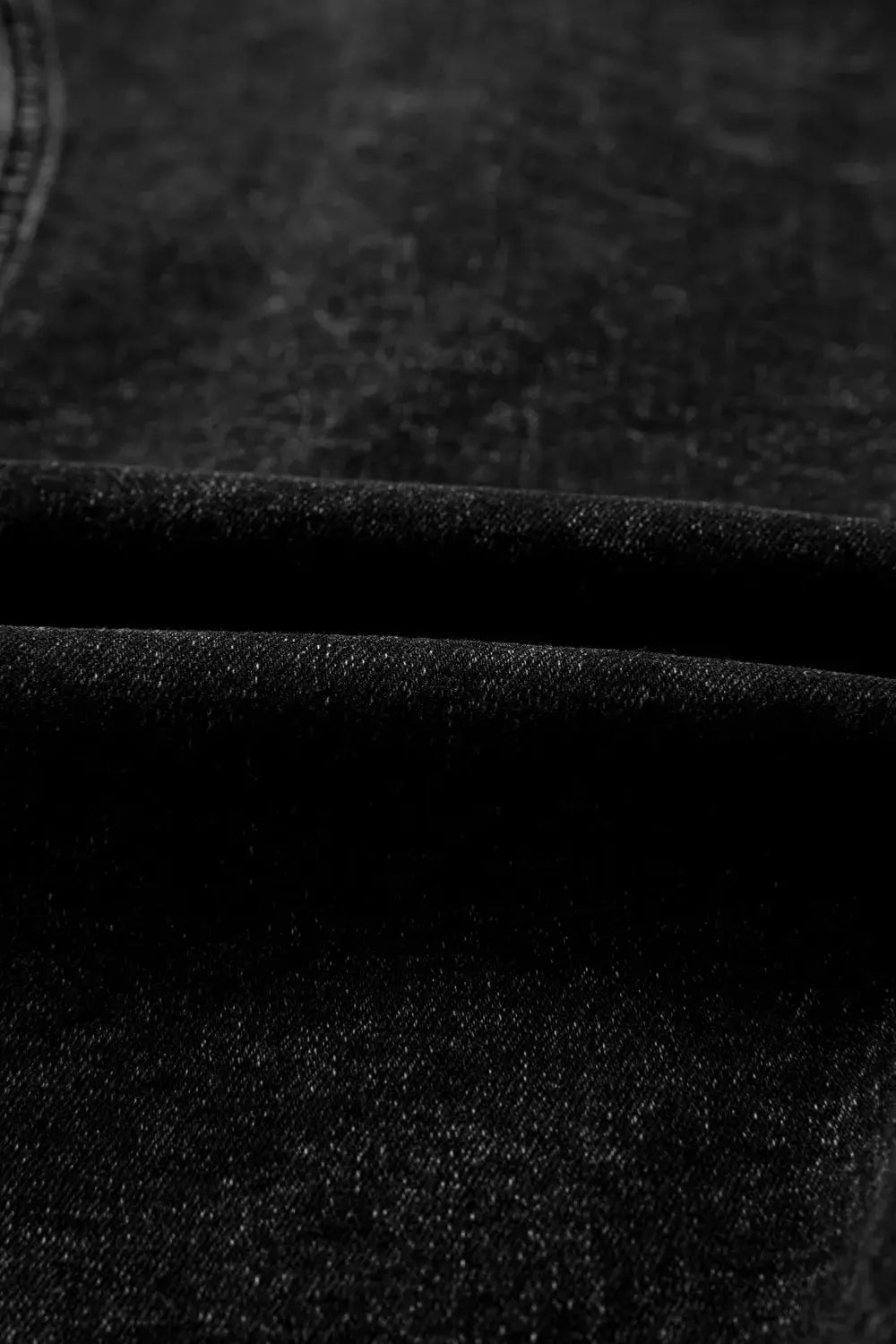 Denim vest close-up in vintage-wash dark indigo cotton fabric
