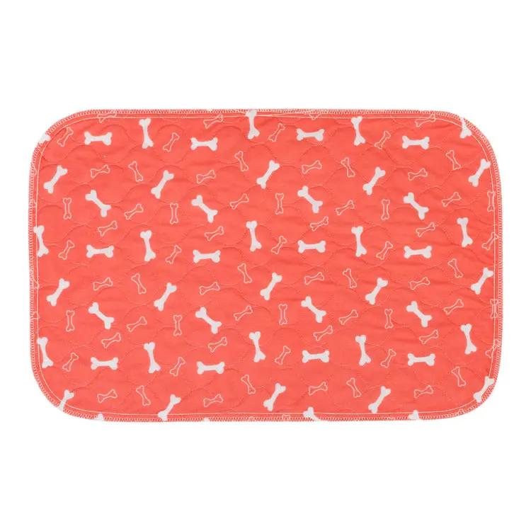 Three-layer waterproof pet absorbent pad by AdTec in coral with white bone pattern