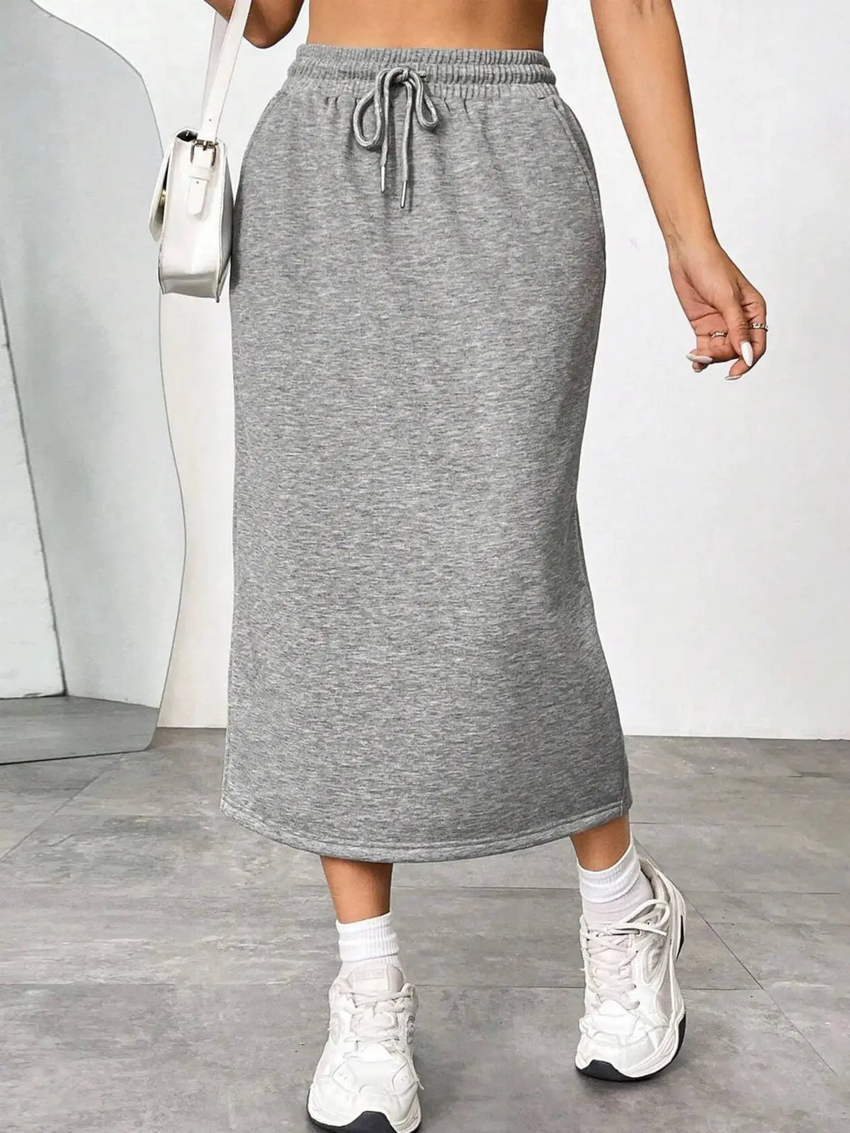 Slit drawstring midi skirt in heather grey knit fabric.