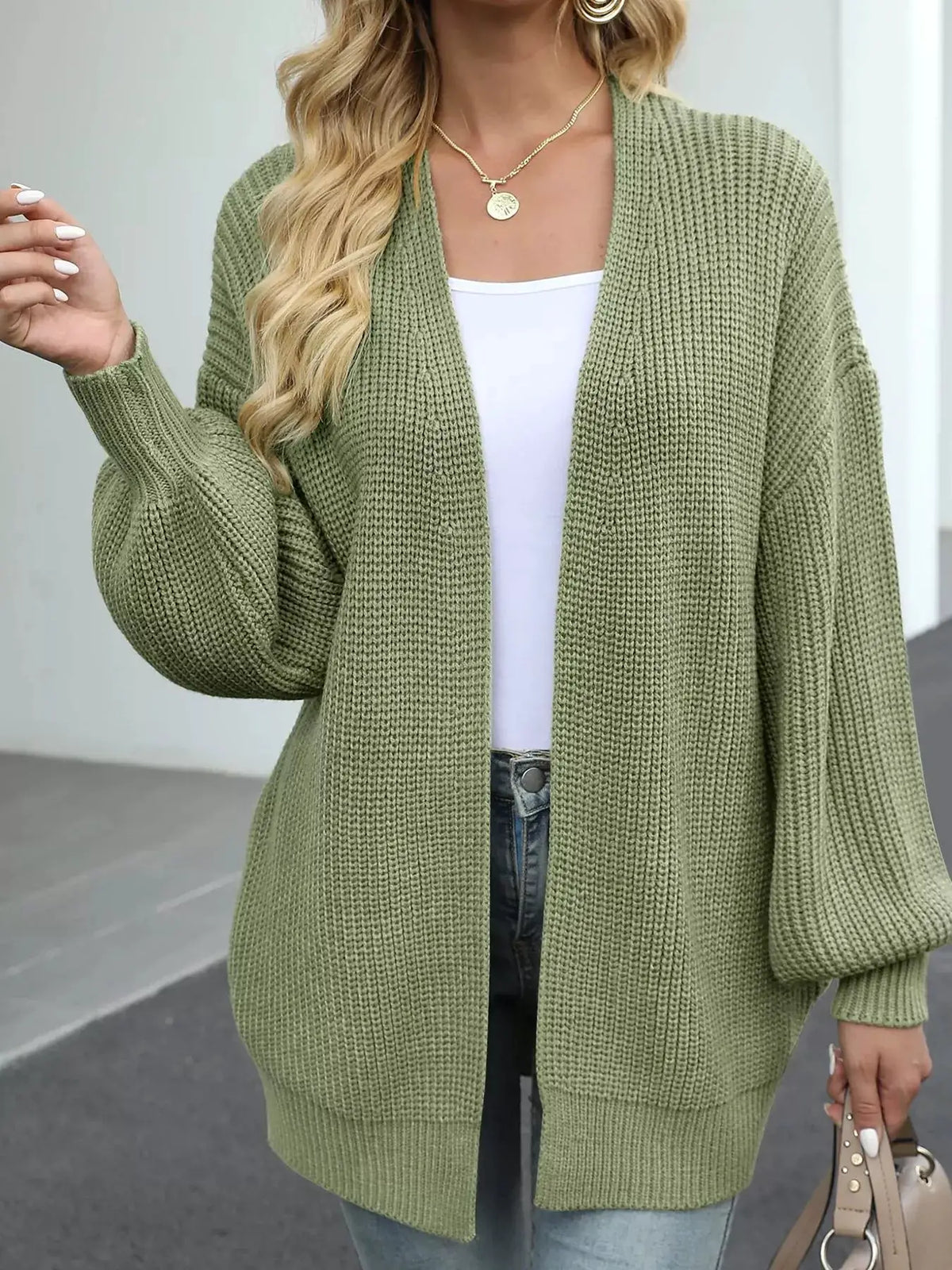 Cozy oversized chunky knit open-front cardigan in olive green with lantern sleeves.
