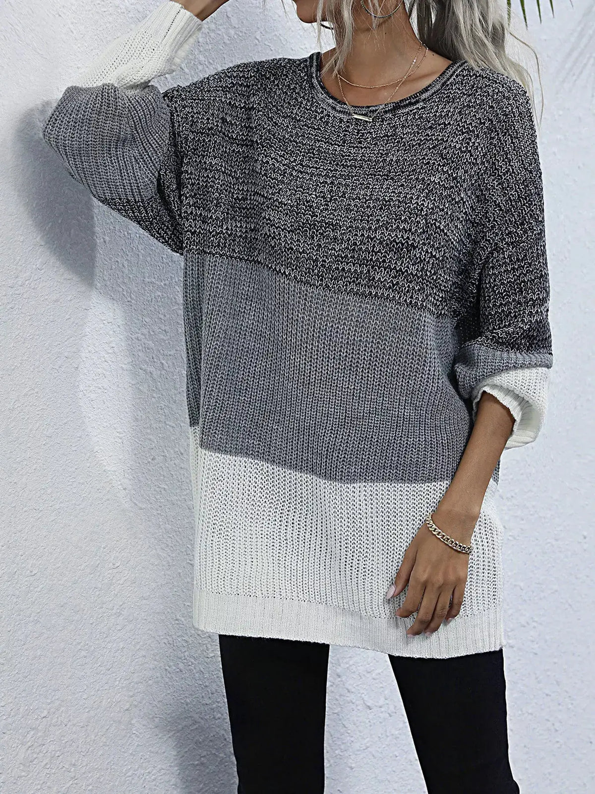 Color-block oversized knit sweater with a round neck; grey gradient with white cuffs and hem.