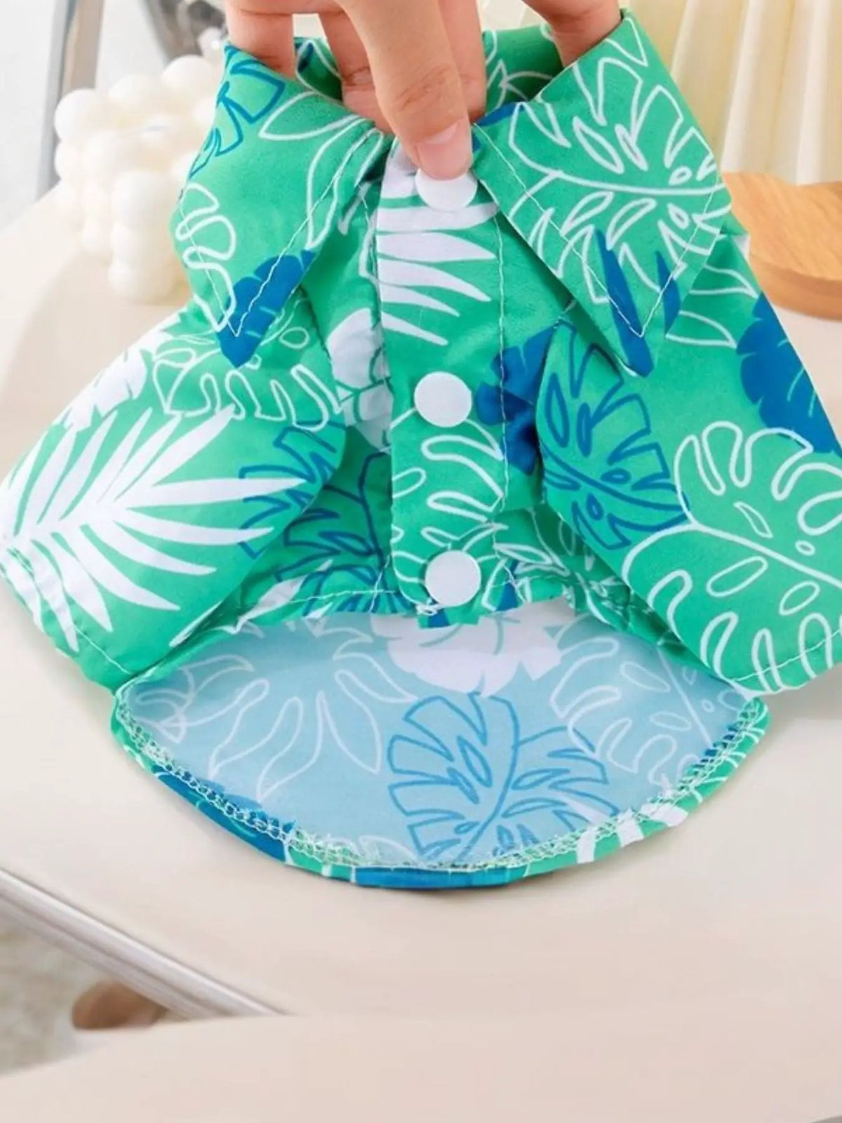 Lightweight Pet Top in green tropical leaf print with white snap buttons by Trendsi