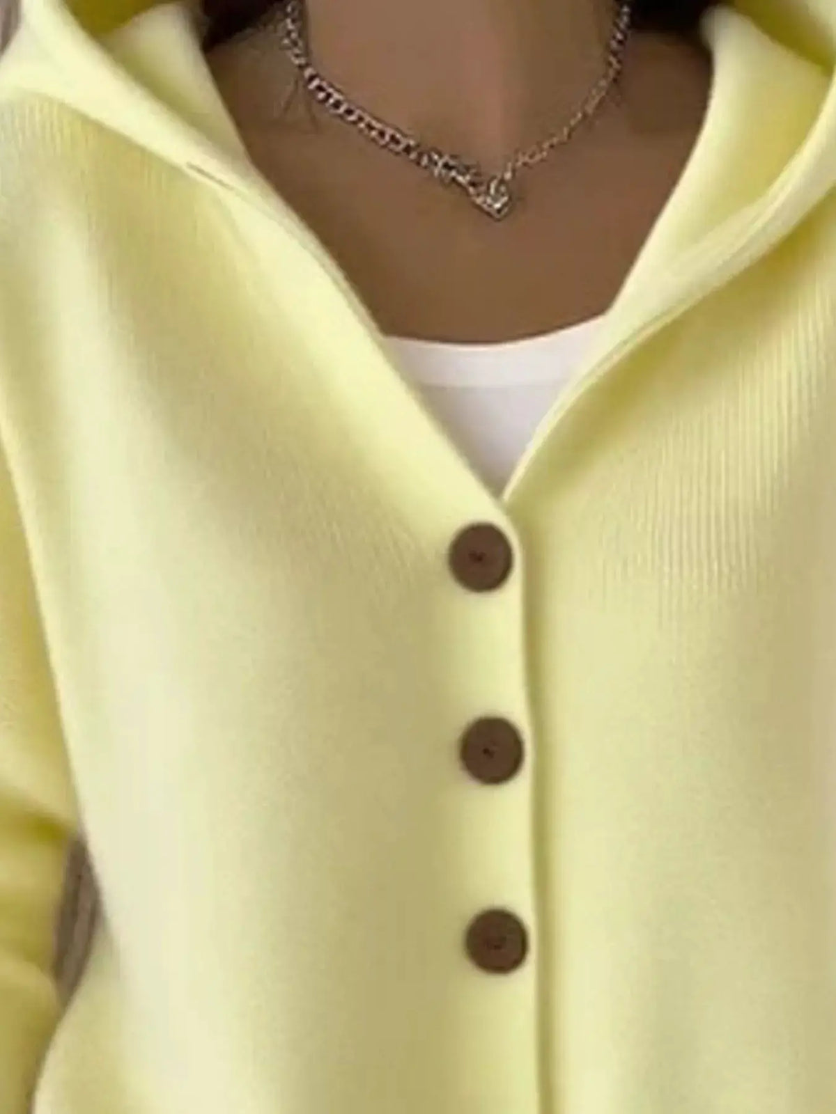 Plus size hooded button-front soft knit cardigan in pale yellow with brown buttons by Trendsi.