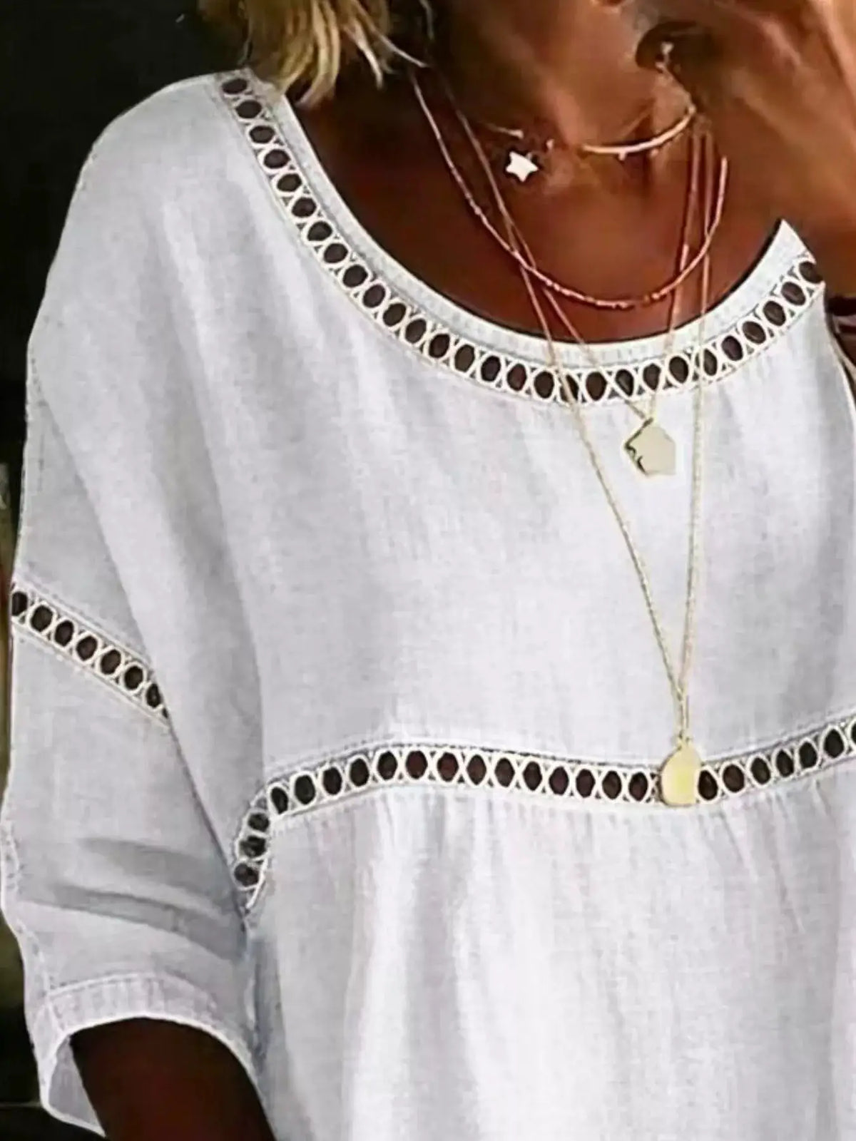 Plus-size white hollow-out round-neck top with eyelet trim and short sleeves
