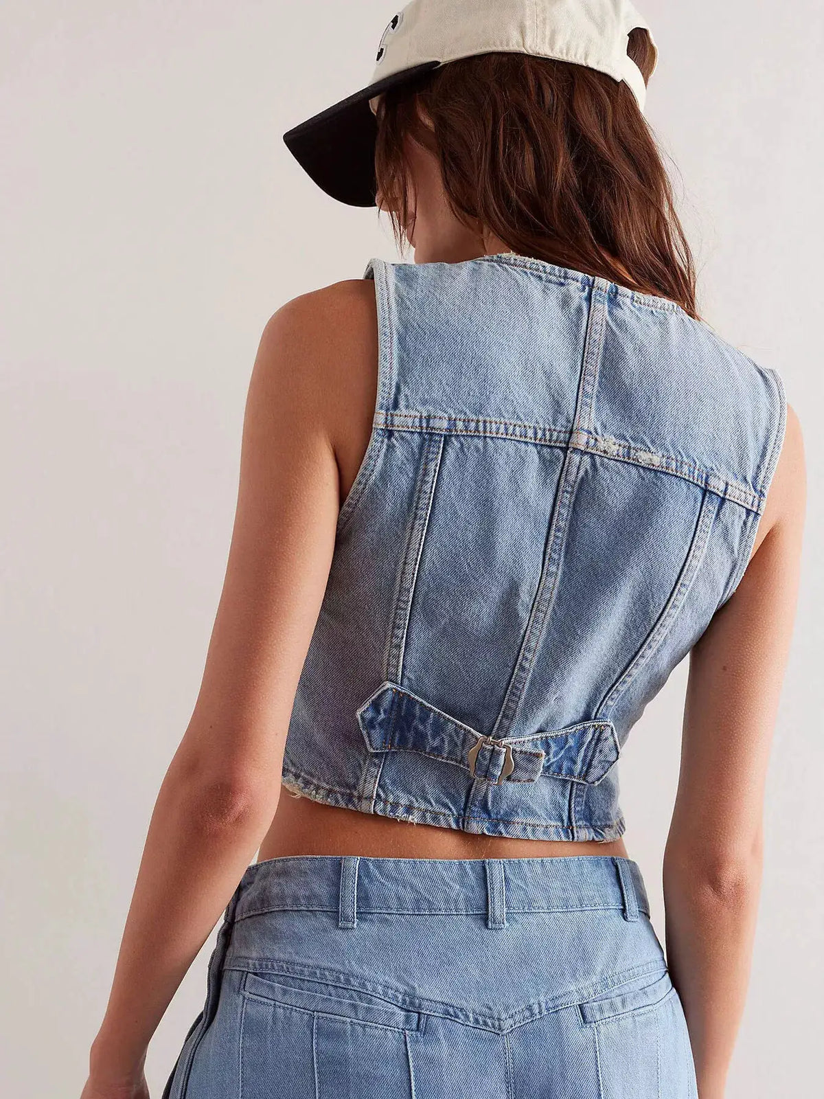 Trendsi lightweight acid-wash denim vest, sleeveless back view with waist strap detail in light blue.