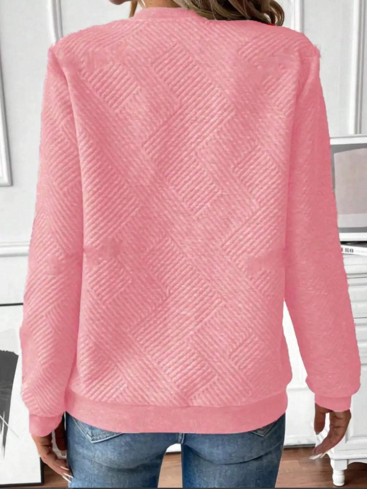 Textured pink quarter-zip sweatshirt by Trendsi, back view with diagonal quilted pattern.