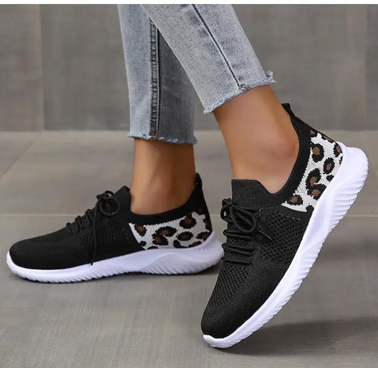 Leopard-print lace-up sneakers by AdTec; black knit upper, white sole, pair.