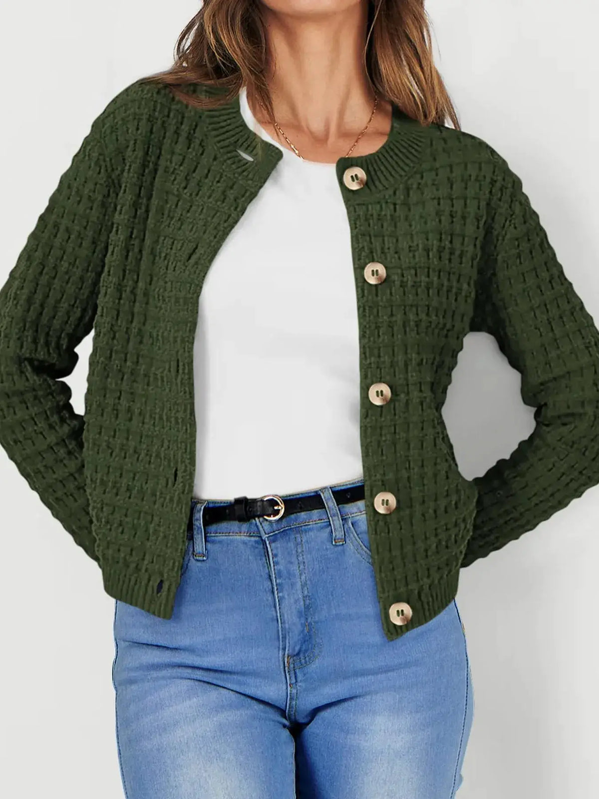 Textured stretchy knit button-front cardigan in olive green with beige buttons, worn over white top and blue jeans