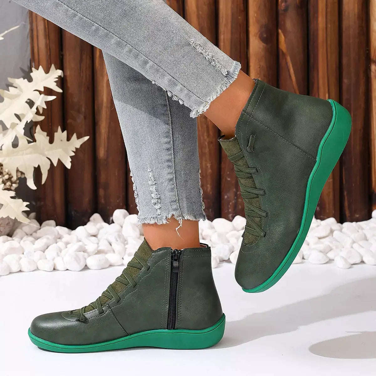 Pair of green lace-up faux leather ankle boots with green wedge sole and side zipper