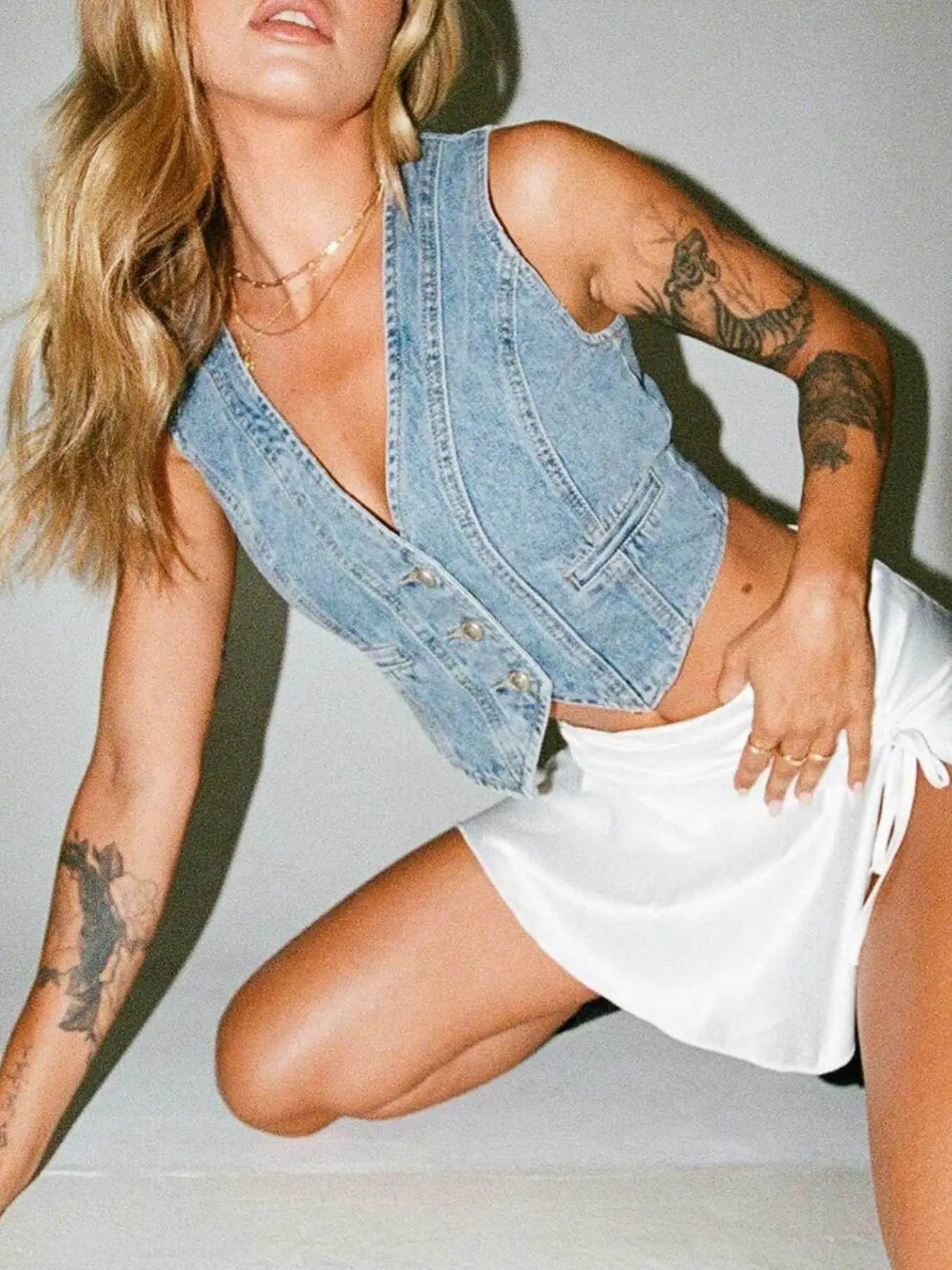 V-neck denim vest in light blue cotton-blend with button-front.