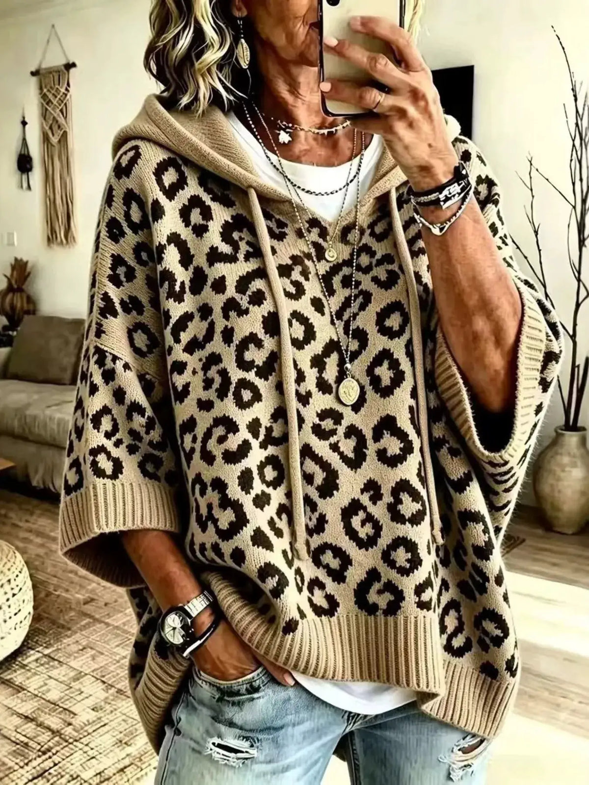 Drawstring leopard hooded sweater; beige knit with black leopard print, hood with drawstrings.