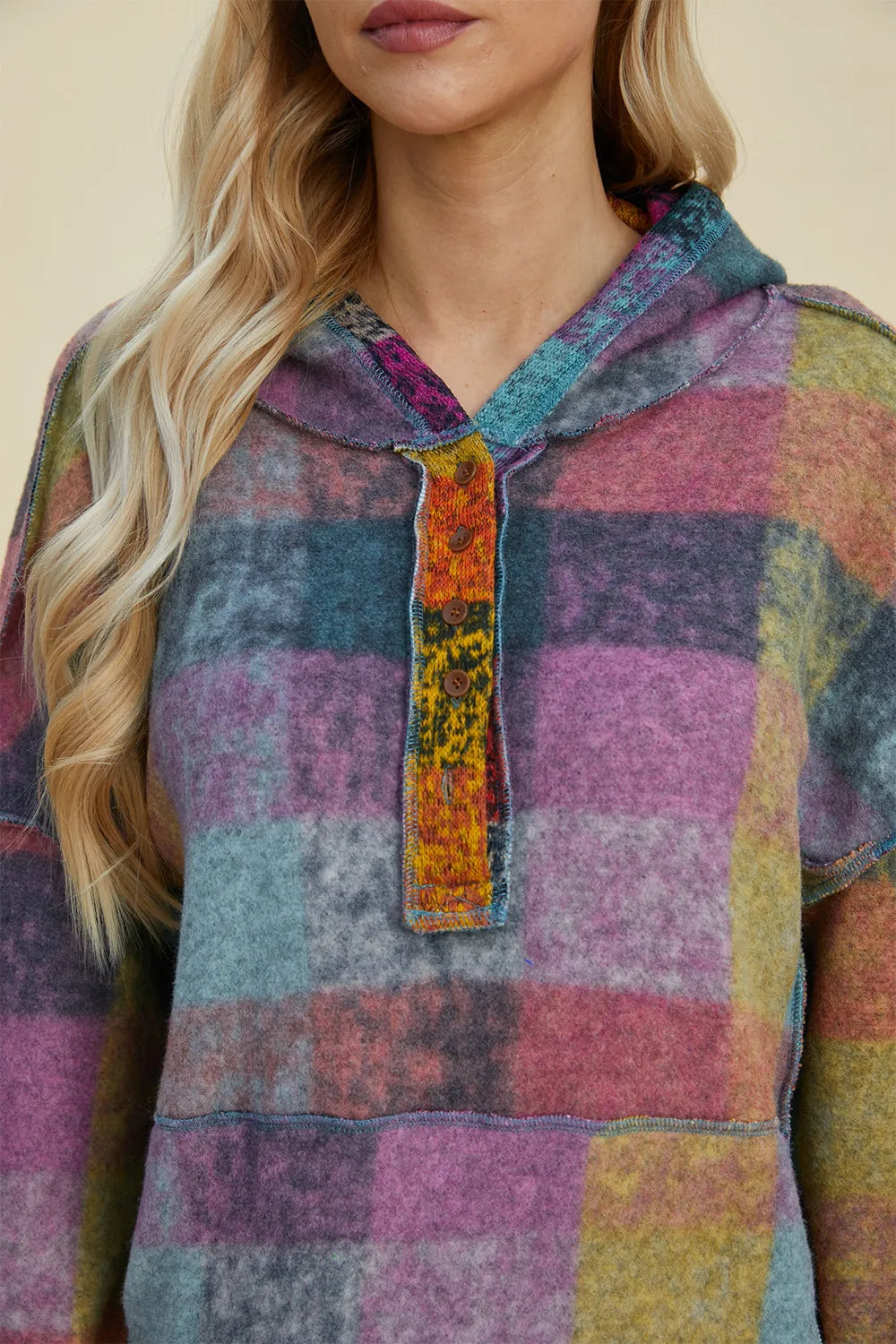 Plus-size plaid fleece hoodie with dropped shoulders and front button placket in multicolor patchwork.