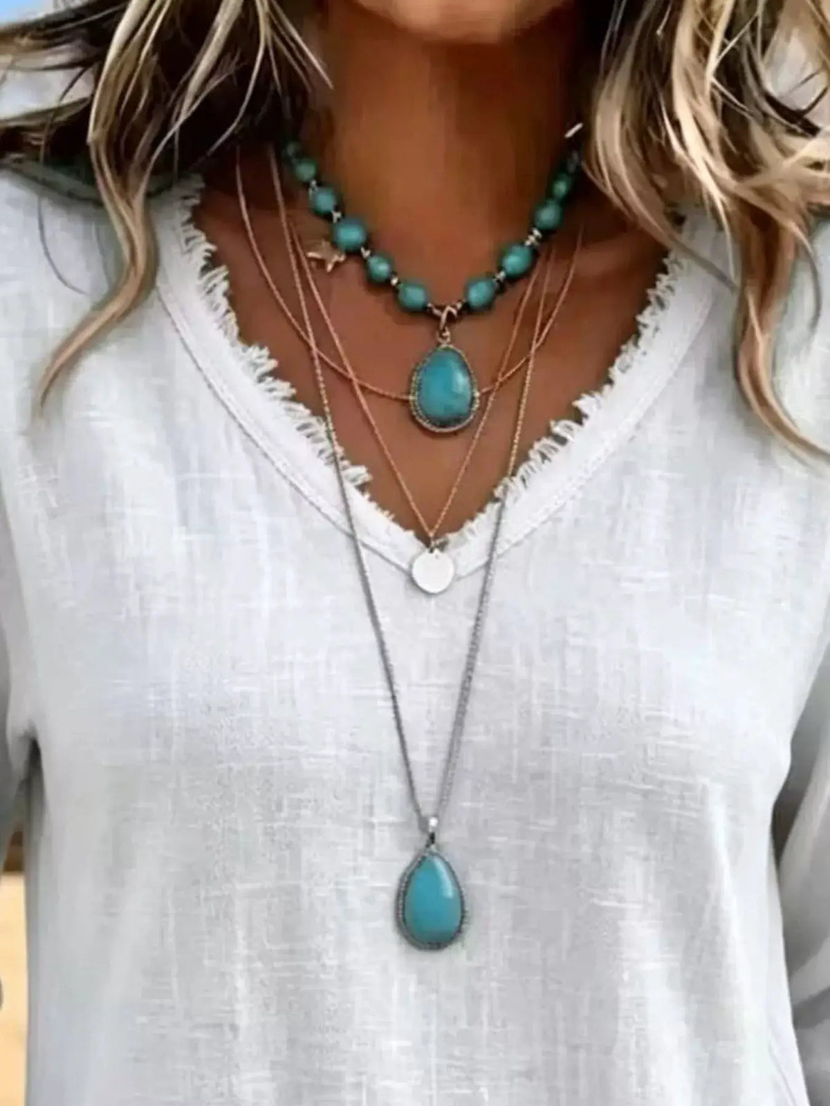 V-Neck Frayed Hem Long Sleeve T-Shirt in white, layered with turquoise bead and pendant necklaces.
