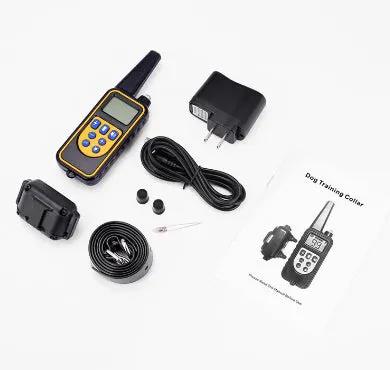 AdTec remote dog training kit with yellow trim controller, receiver collar, charger, extra prongs, and manual