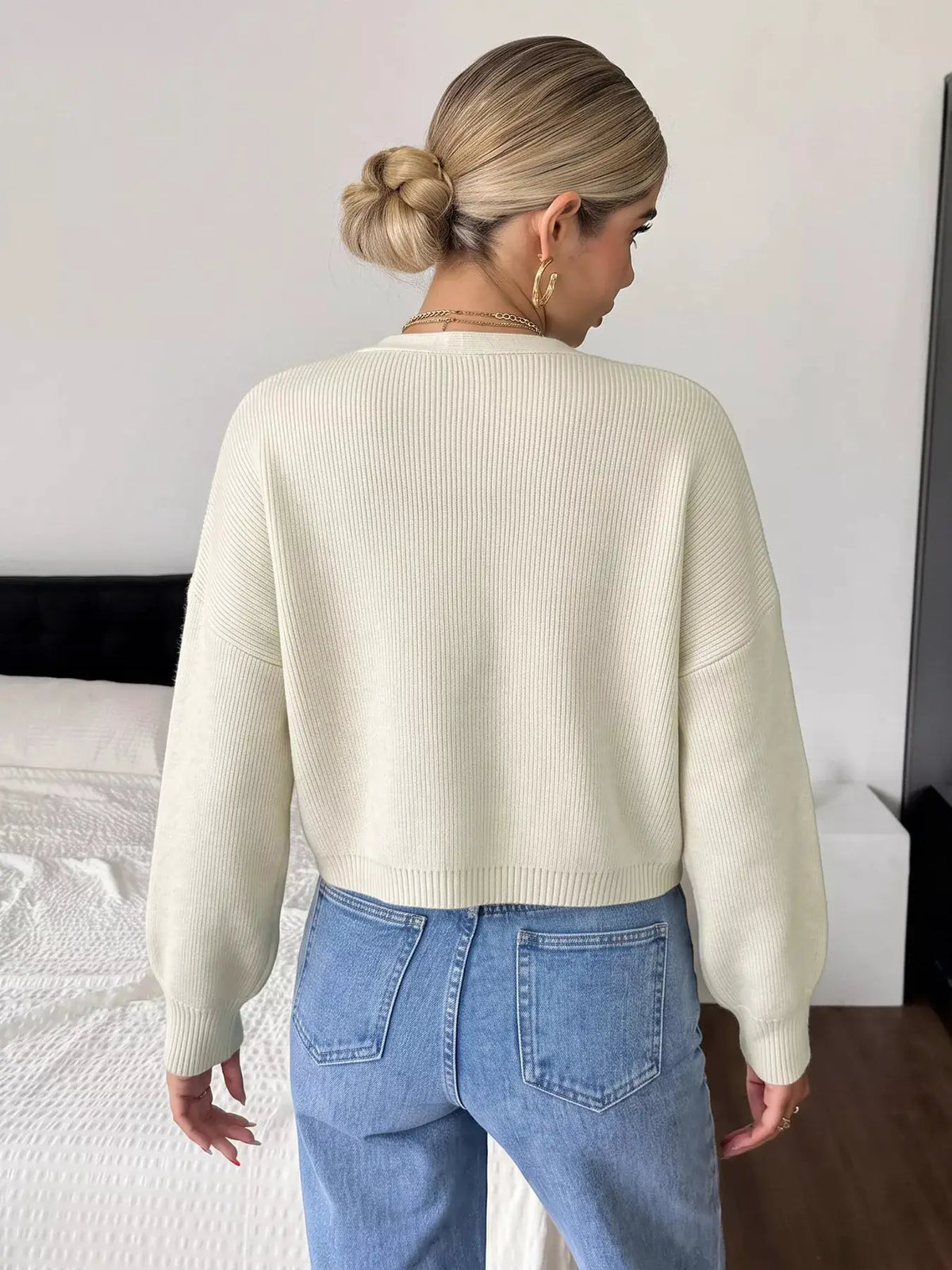 Four-Leaf Clover Open Front Cardigan in cream ribbed knit with long sleeves.