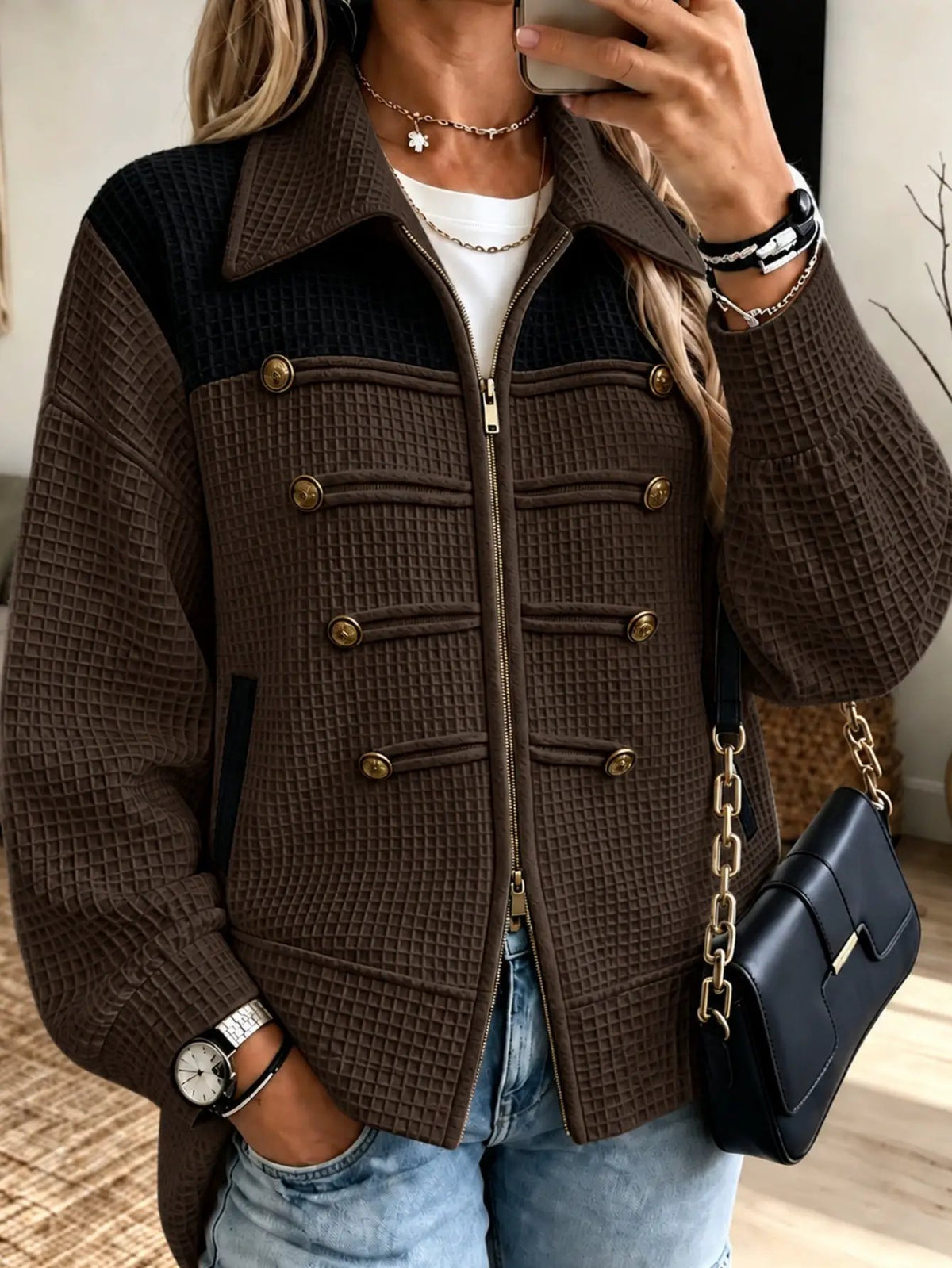 Lady's jacket in brown quilted fabric with black yoke, gold-tone buttons and front zipper.