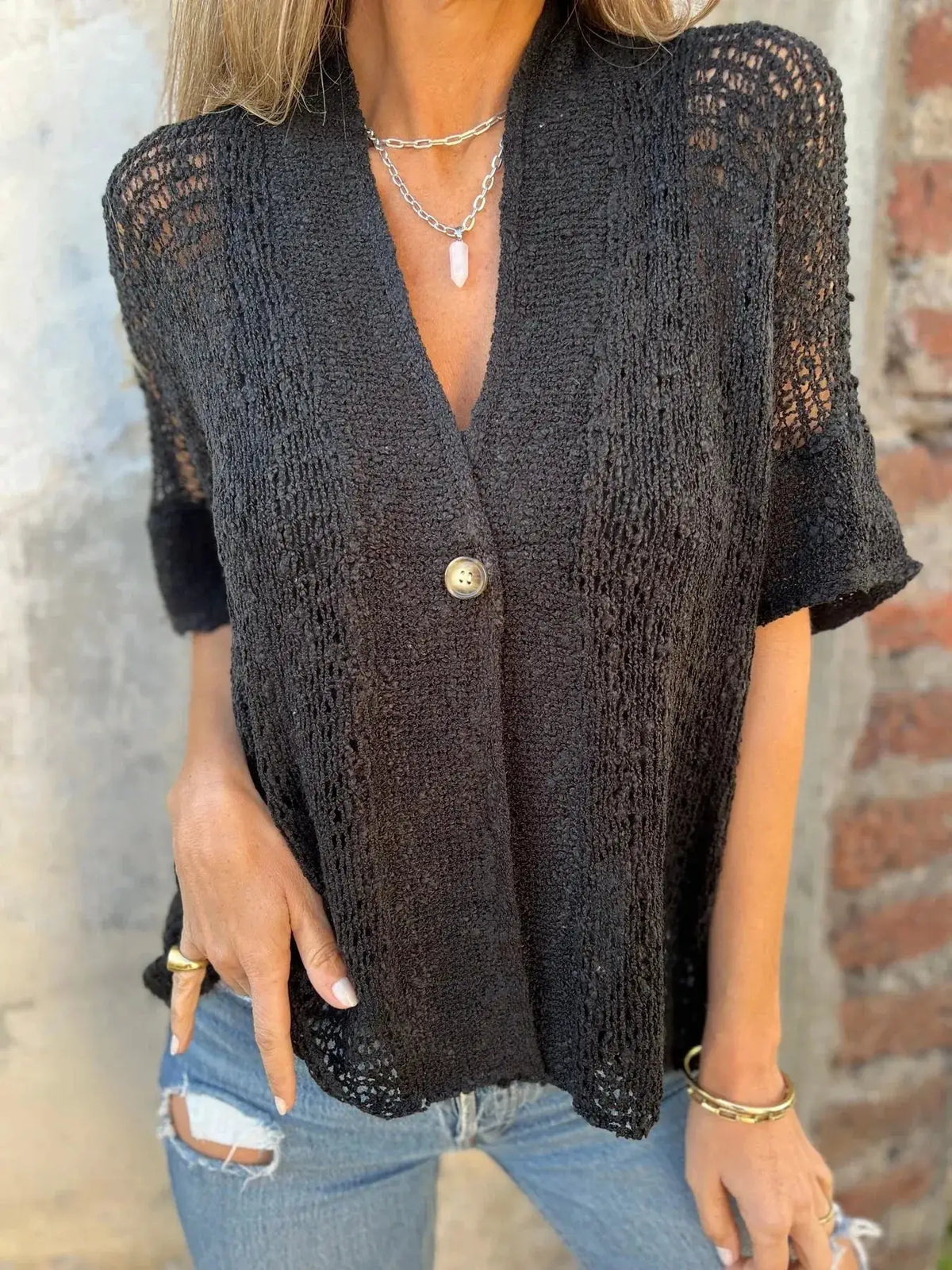 Plus size openwork cardigan in black; sheer knit with one front button and short sleeves