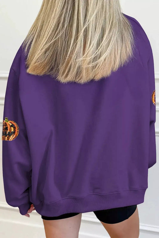 Sequin pumpkin Halloween sweatshirt in purple with pumpkin sequin patches on sleeves.