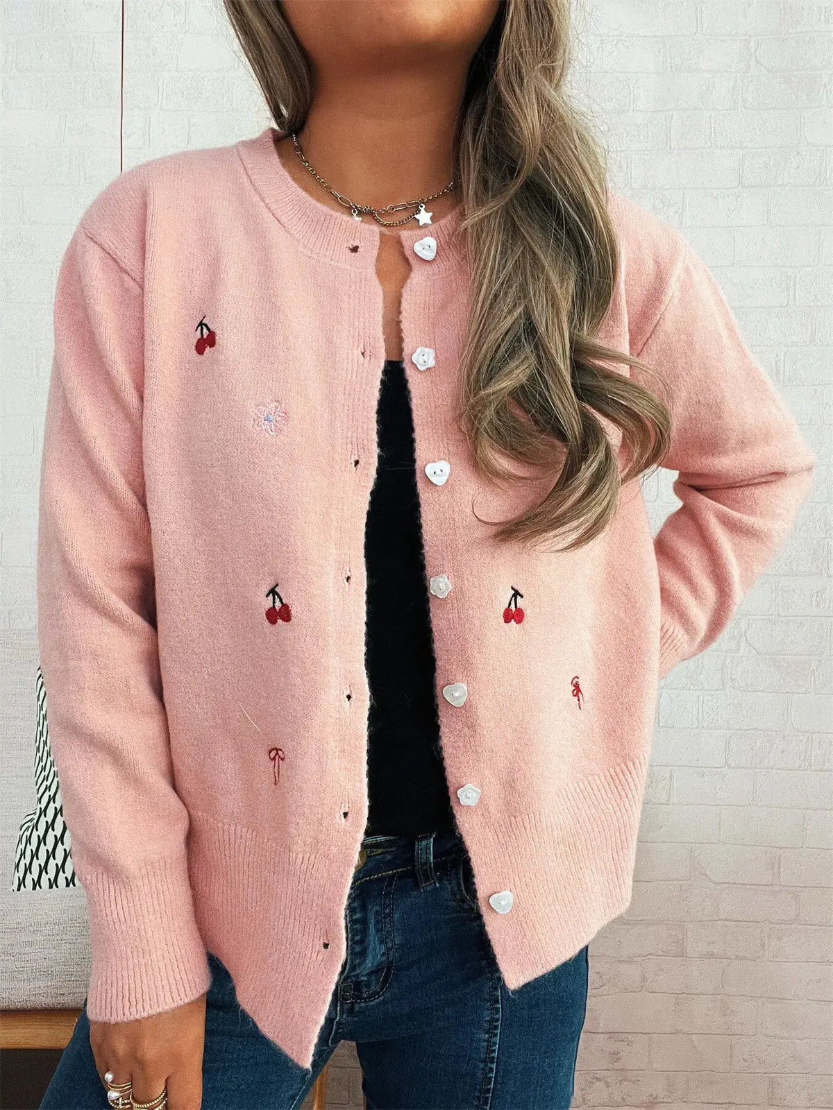 Ribbed pink knit cardigan with white heart buttons and cherry embroidery