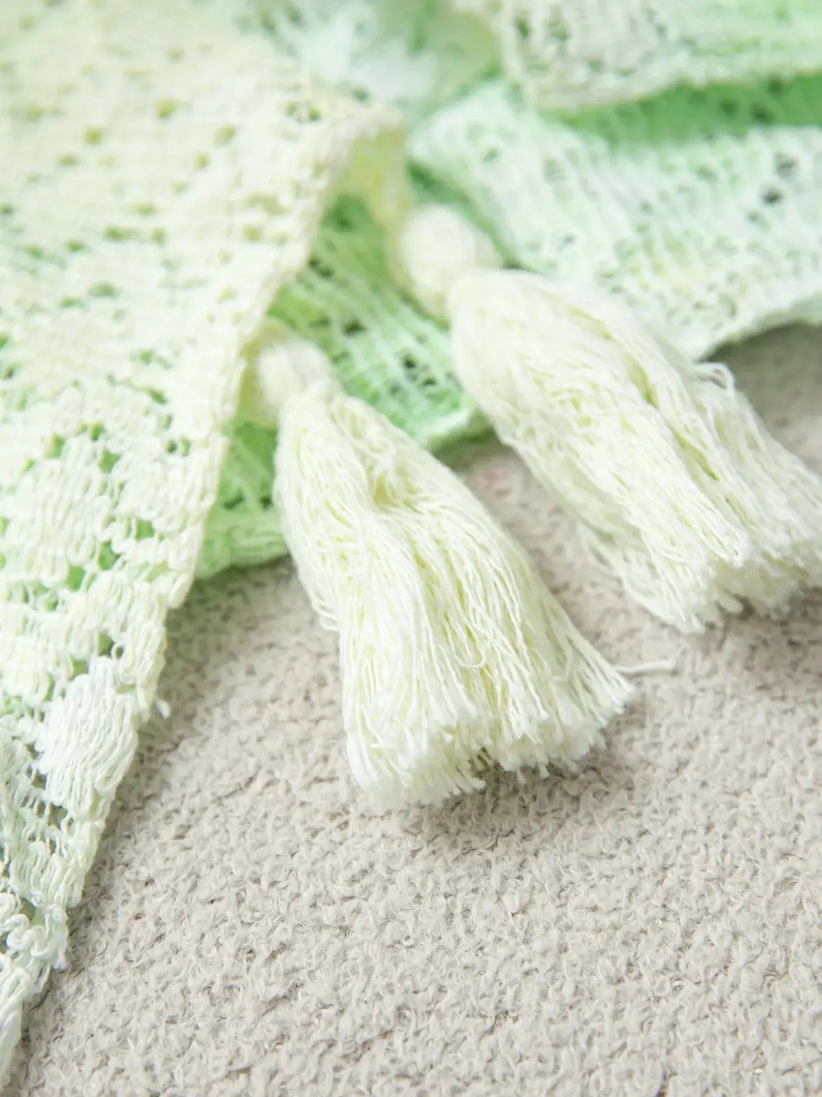 Lightweight gradient openwork knit tassel beach cover-up in pale lime to mint green