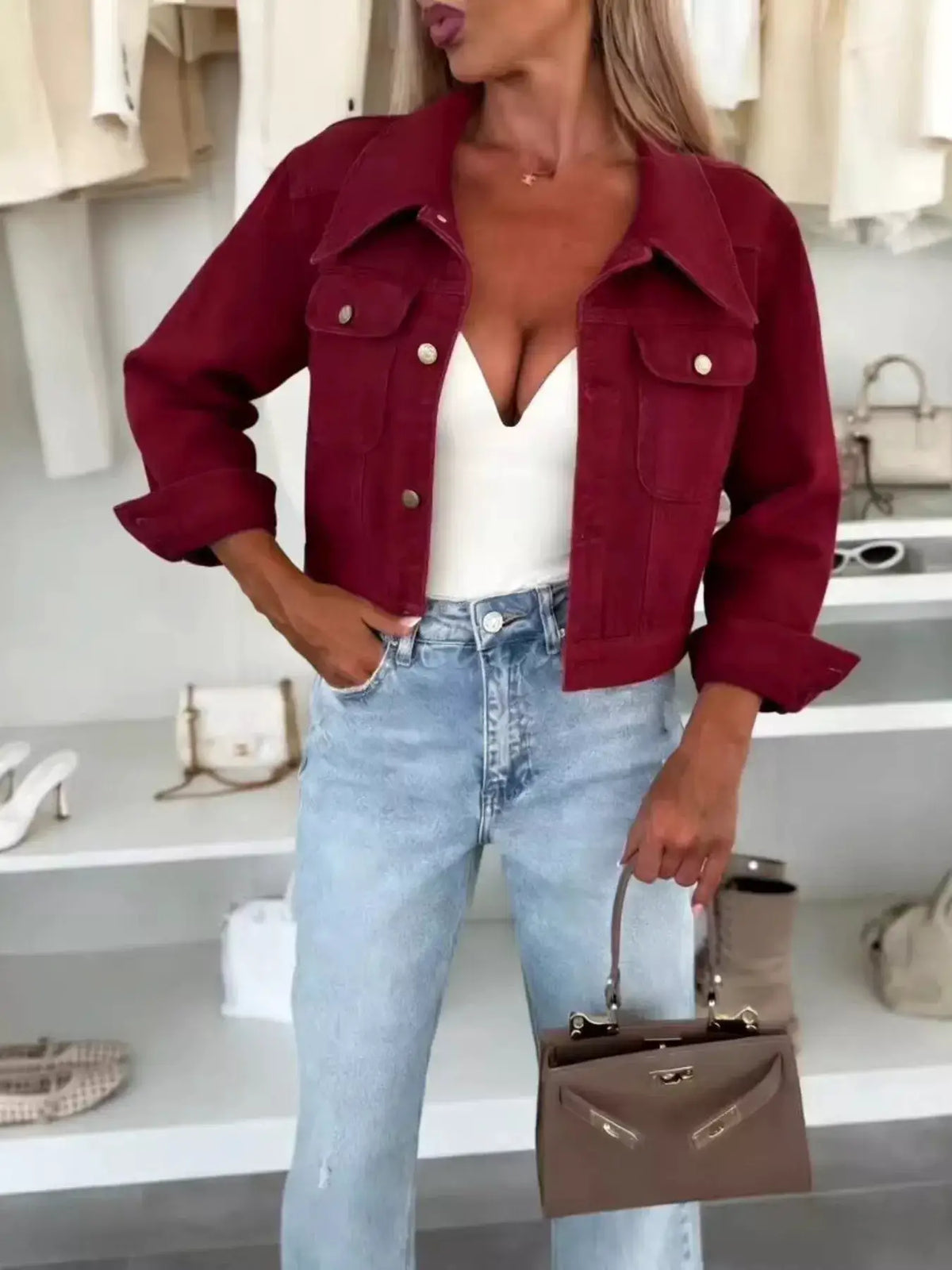 Plus-size cropped burgundy denim jacket with gold buttons, slim-fit over white top.