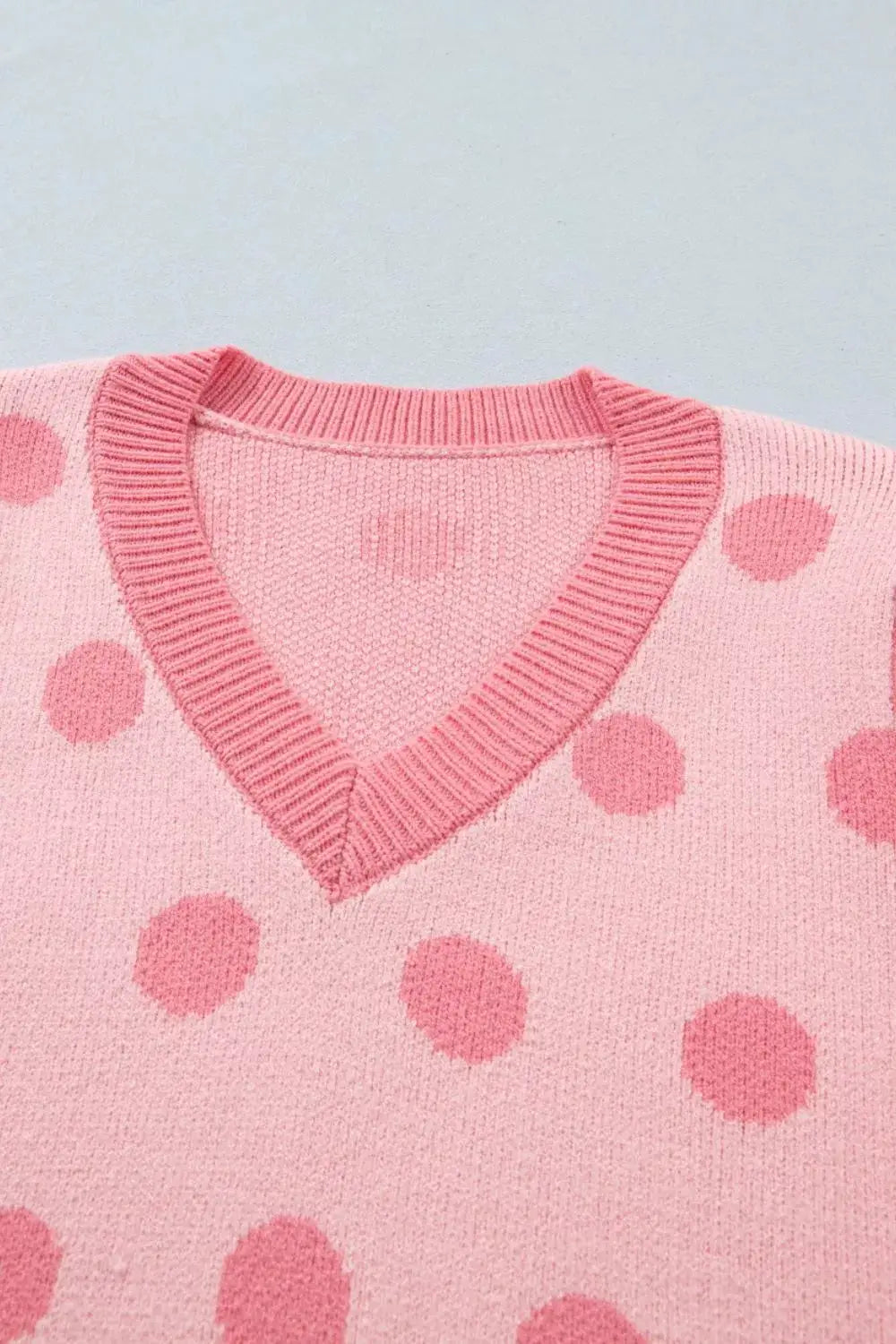 Chic pink polka-dot knit sweater top with V-neck, ribbed trim and gentle stretch