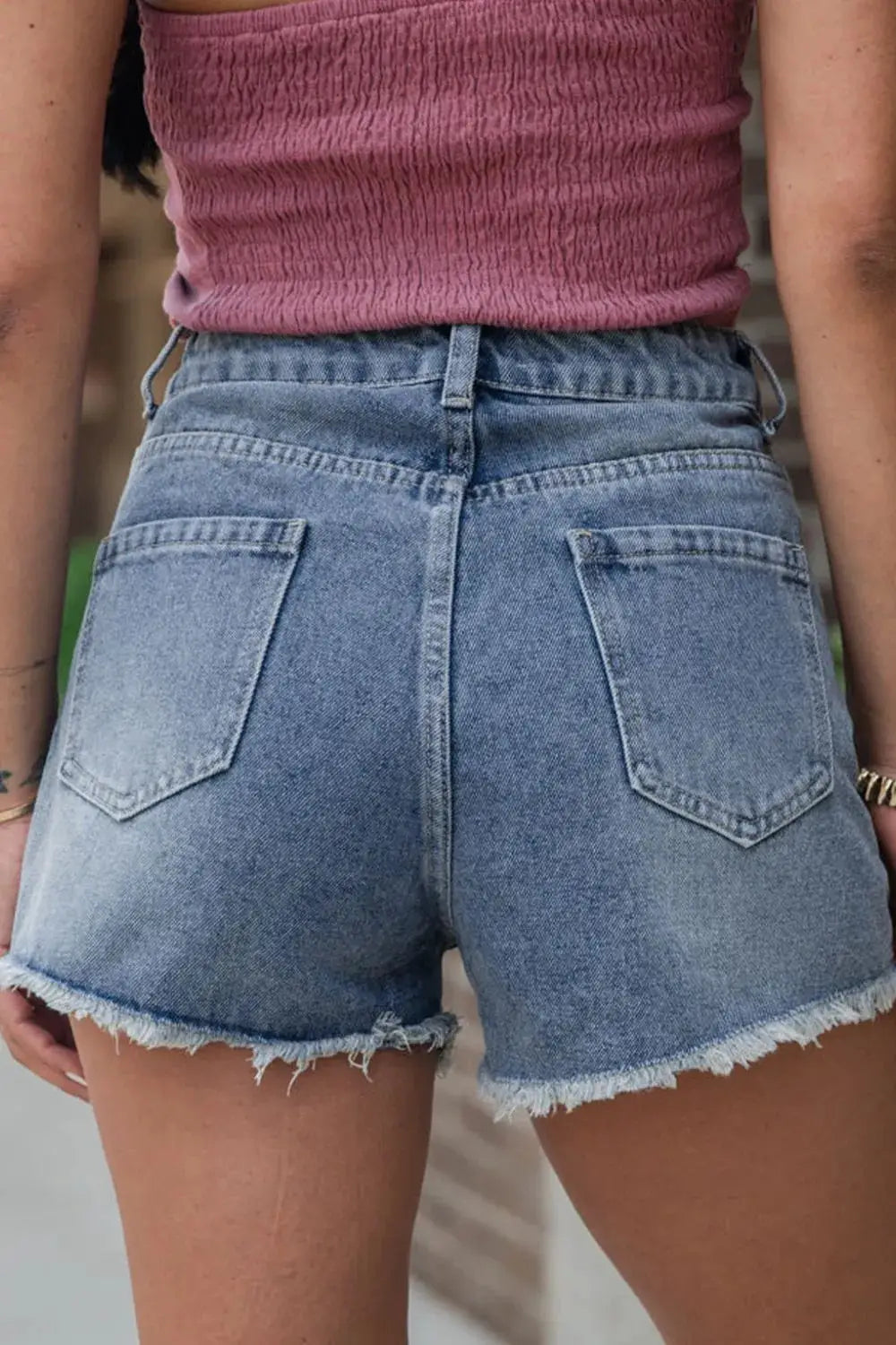 Classic Pearl Beaded Raw Hem Washed Cotton Blend Denim Shorts, back view in light blue