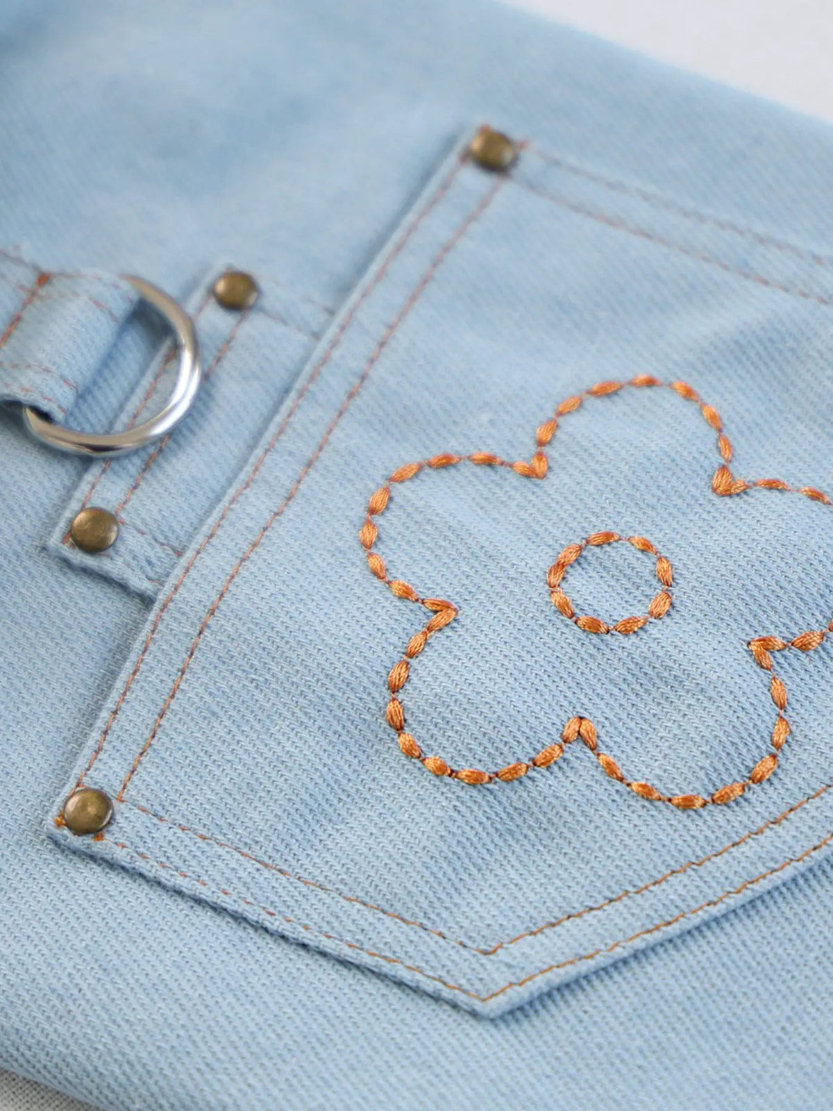 Denim Flower Embroidered Pet Top with orange stitching and metal hardware