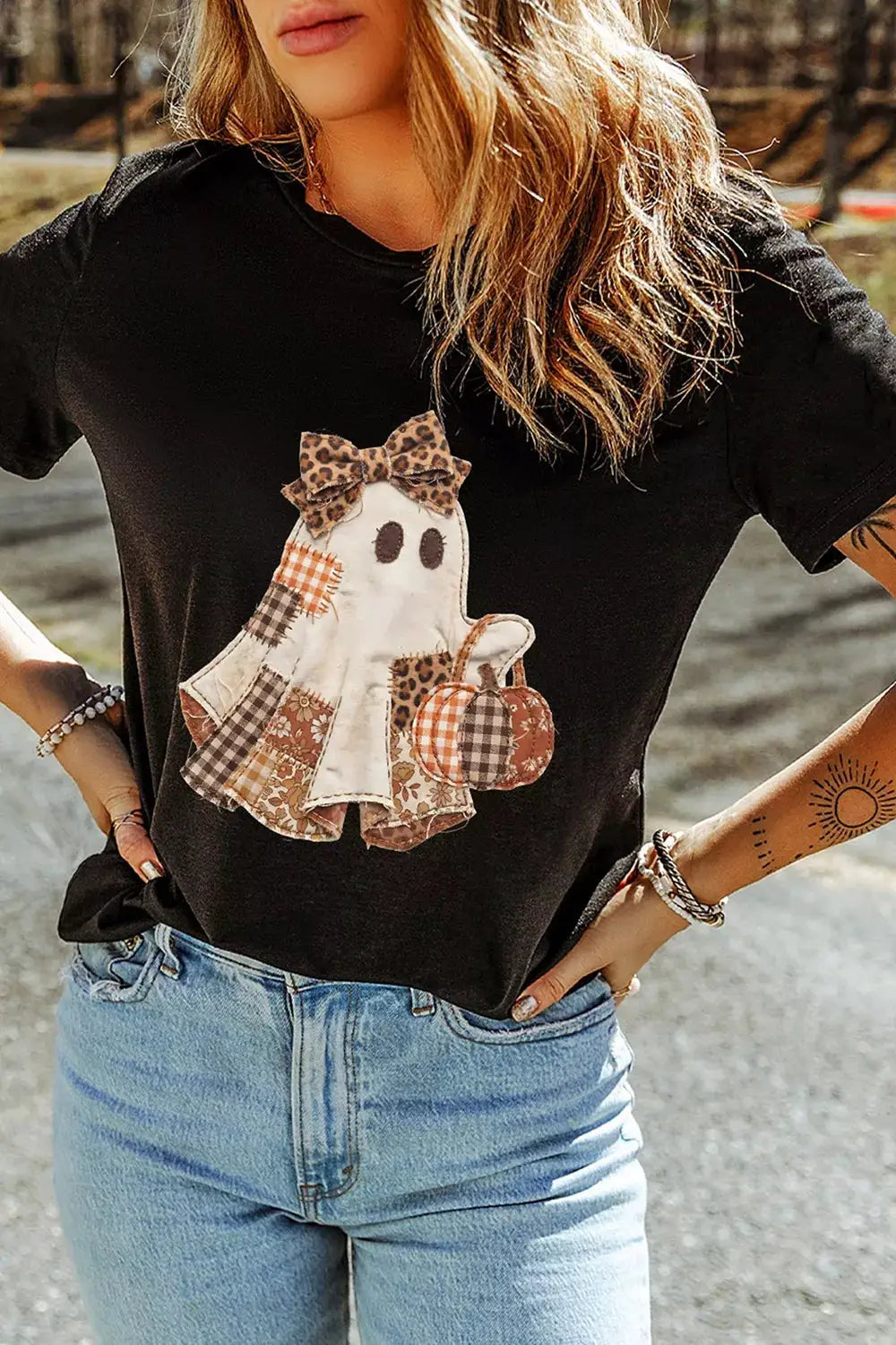 Trendsi full-size Halloween ghost applique tee; black short-sleeve top with patchwork ghost and bow.