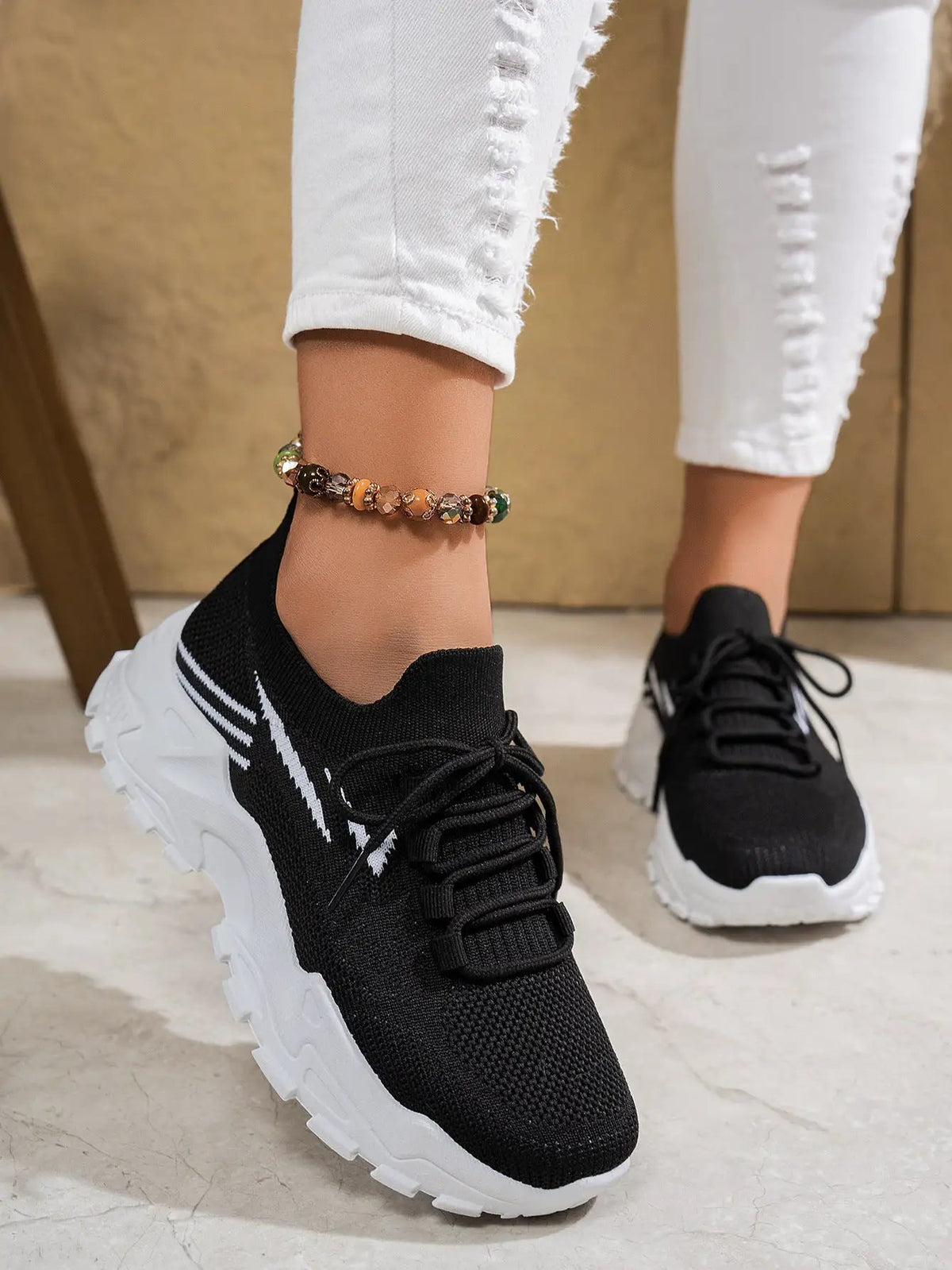 Women's lightweight casual sports shoes in black with a soft bottom and chunky white sole