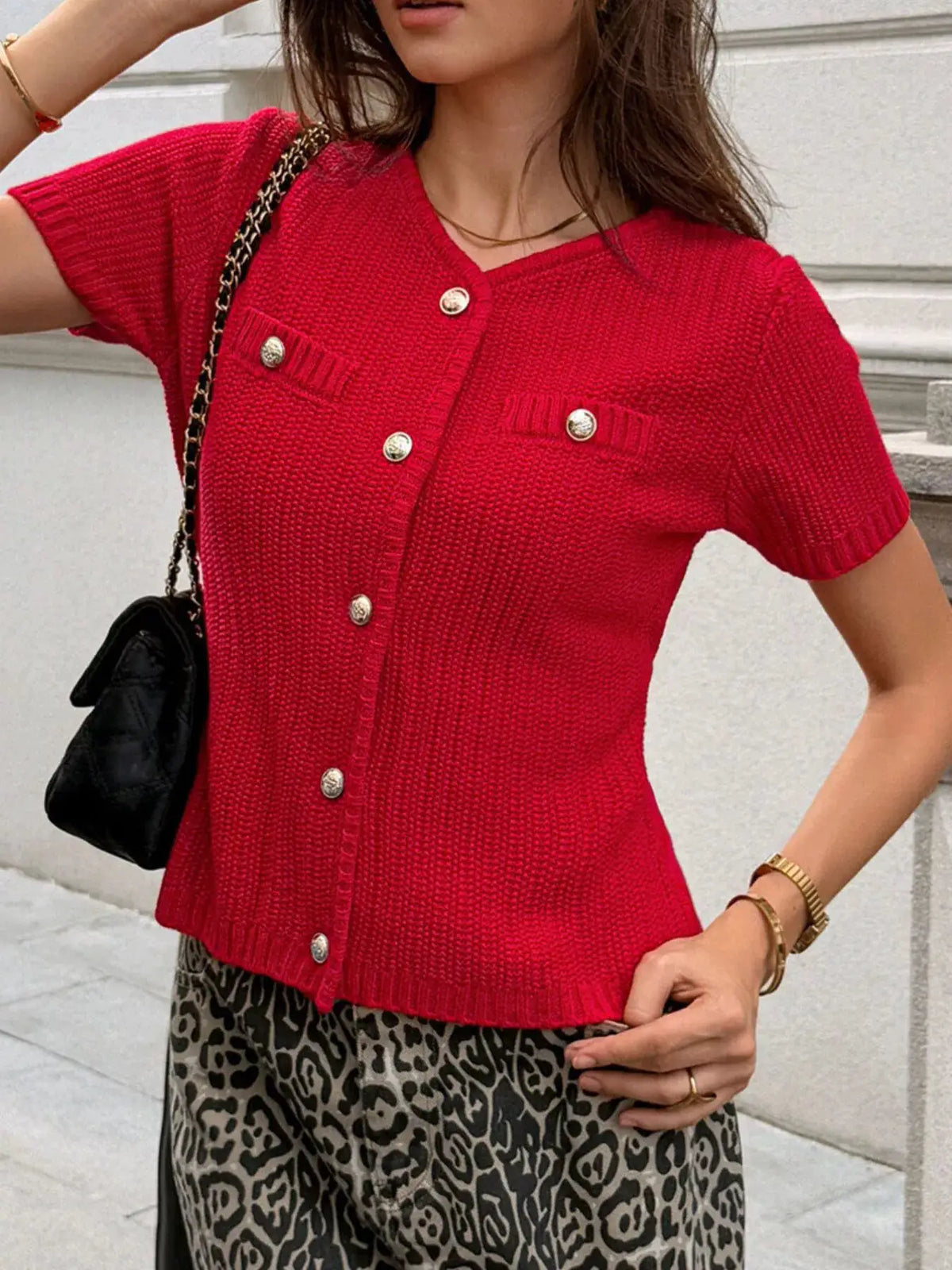 Button-down red acrylic-blend cardigan with short sleeves and gold buttons.