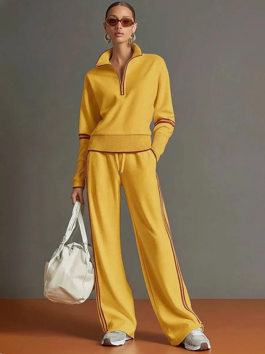 Women active cotton two-piece track suit in mustard yellow with brown-red side stripes; pullover top and wide-leg pants.