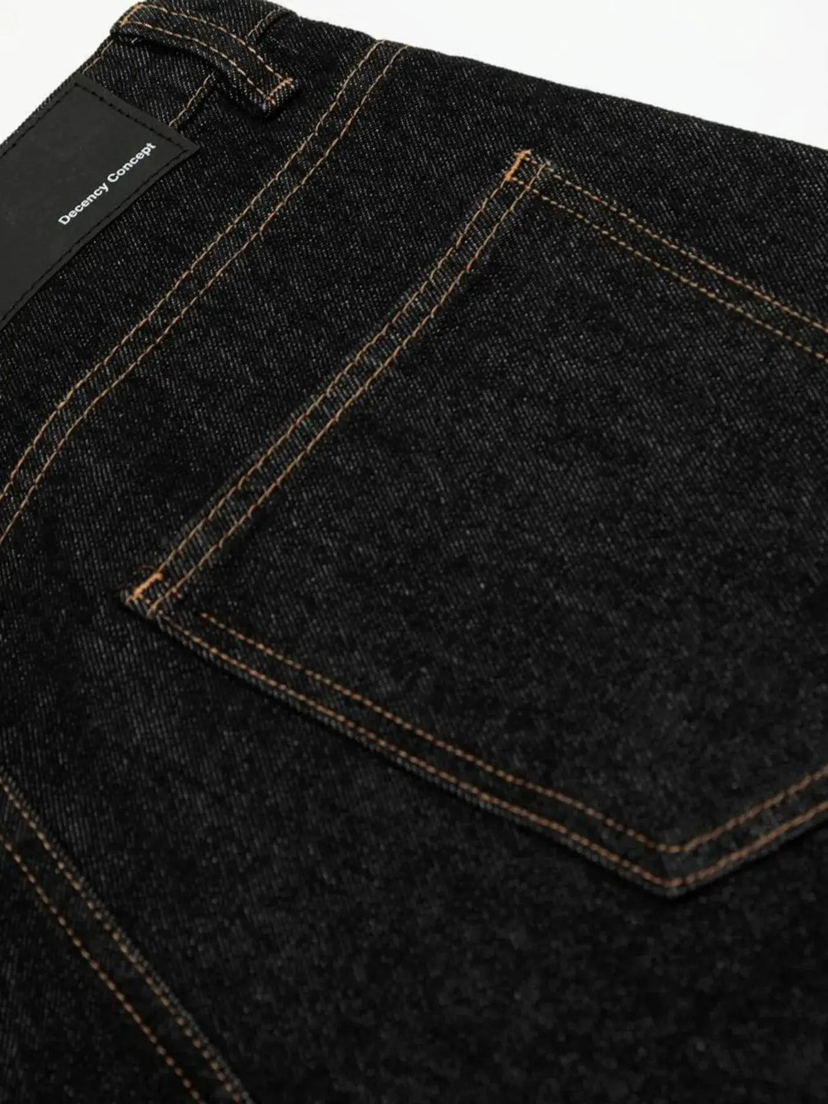 Men's denim shorts in dark indigo with orange contrast stitching and Decency Concept label