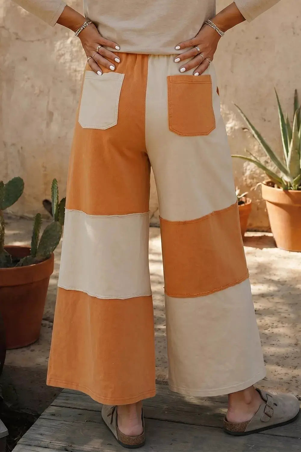 Raw seam colorblock wide-leg ankle-length pants in orange and cream with back patch pockets by Trendsi