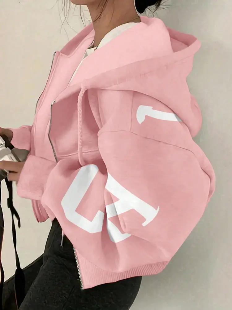 Pink oversized full-zip long-sleeve sweatshirt with a white graphic on the sleeve