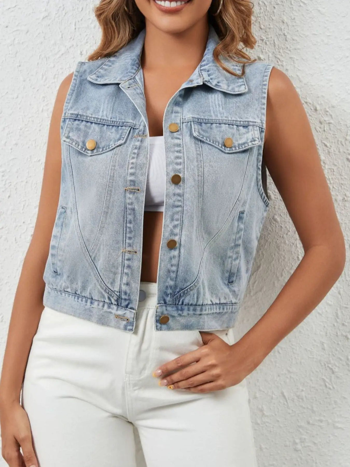 Casual sleeveless denim vest with button front and pockets in light-wash blue by Trendsi