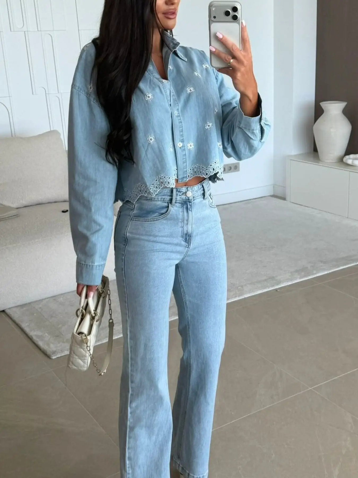 Embroidered cropped denim shirt in light blue with delicate floral embroidery and scalloped hem.