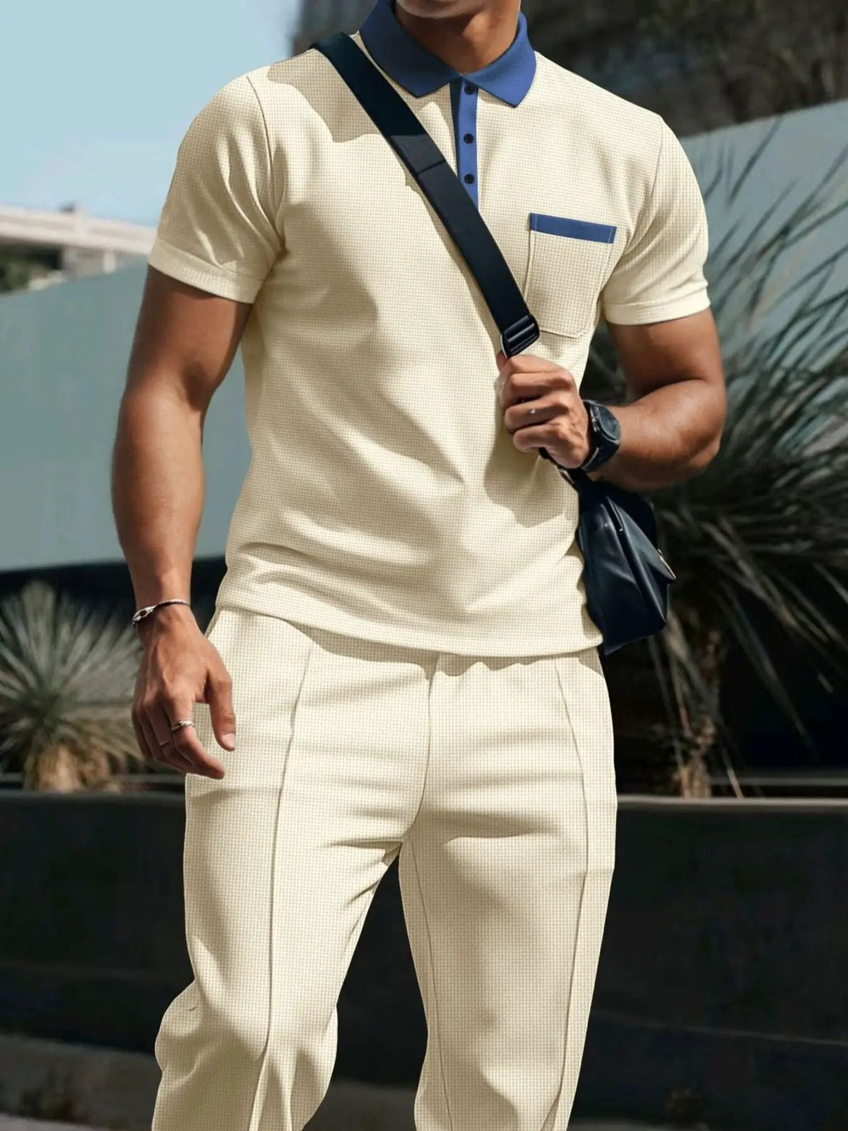 Men's plus-size two-piece polo and pants set by Trendsi in beige with blue collar and pocket trim.