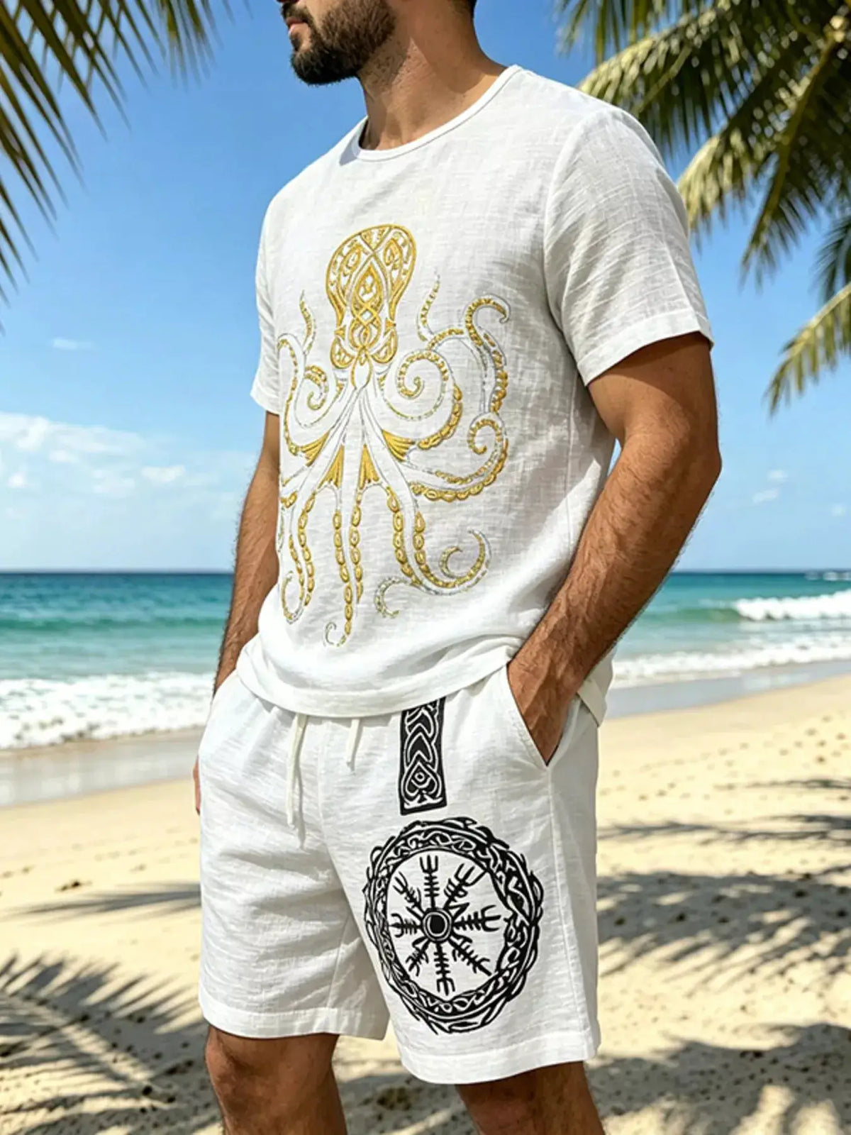 Mens white two-piece loungewear set with tee and drawstring shorts; gold ornate print on tee and black emblem on shorts.