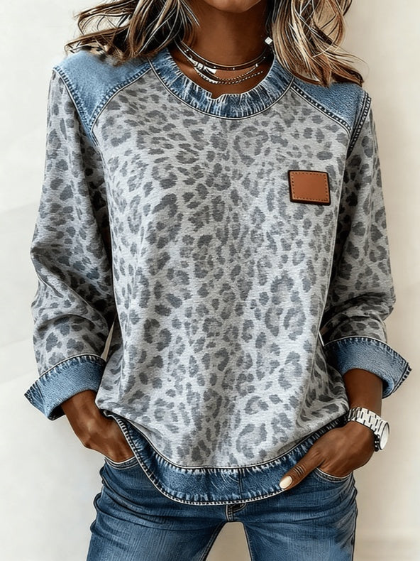 Women's patchwork denim sweatshirt with grey leopard print, blue denim panels, and a brown chest patch.