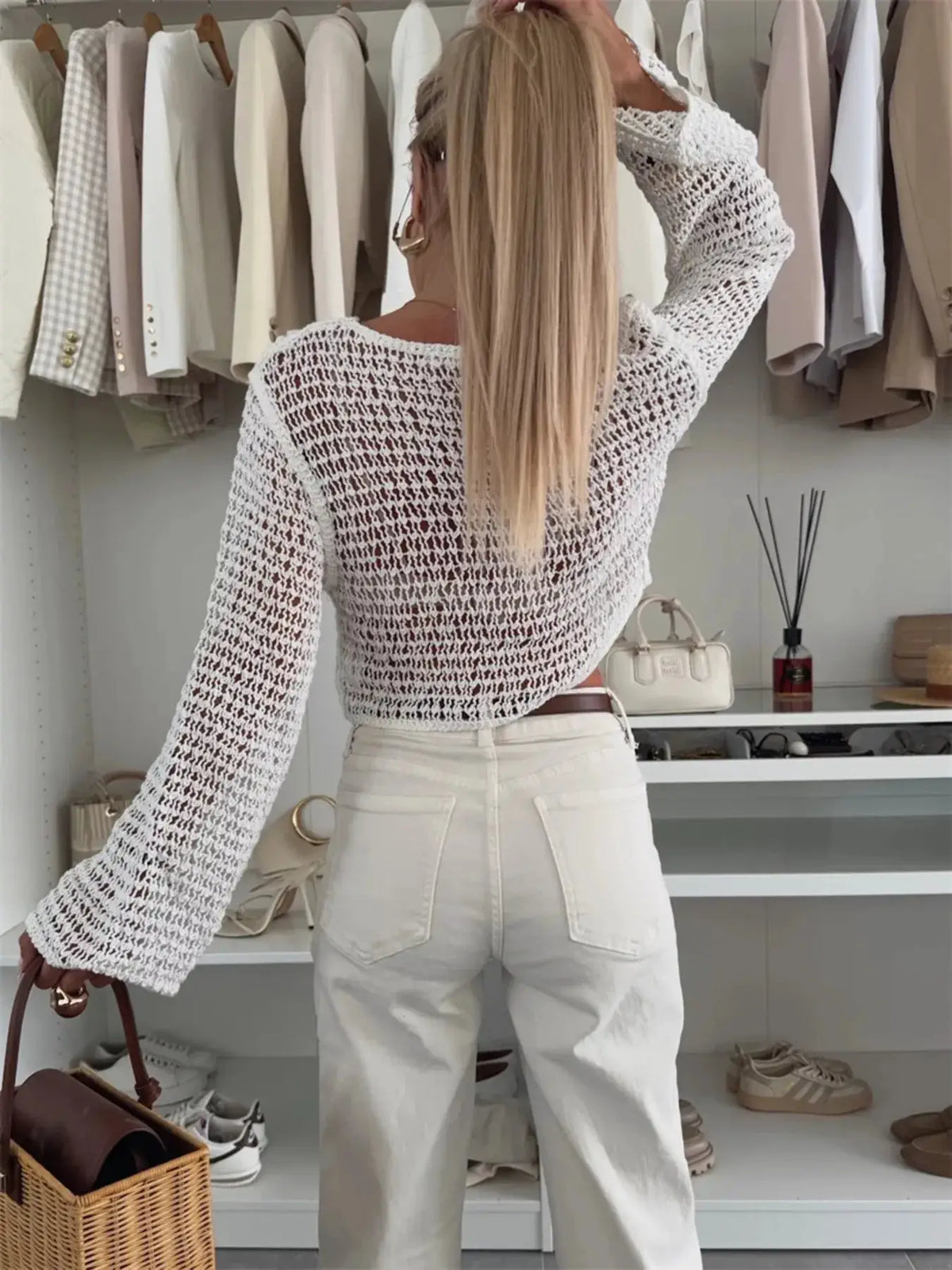 Bikini cover-up top, lightweight white openwork knit with cropped long-sleeve crochet texture.