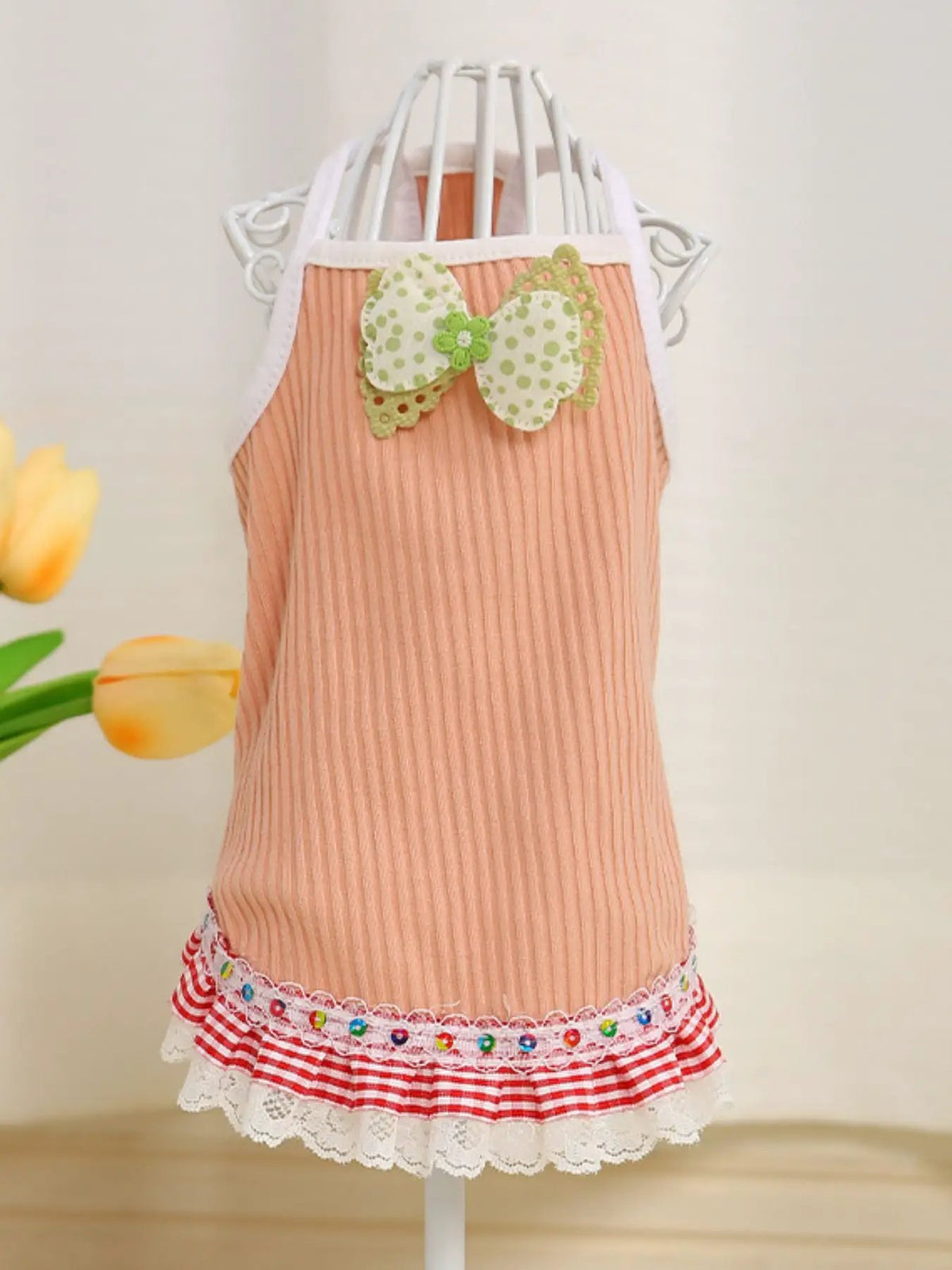 Bowknot Ruffled Hem Pet Top in peach ribbed fabric with white trim and bow applique.