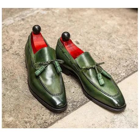 Green leather tassel slip-on loafers with red lining and dark sole